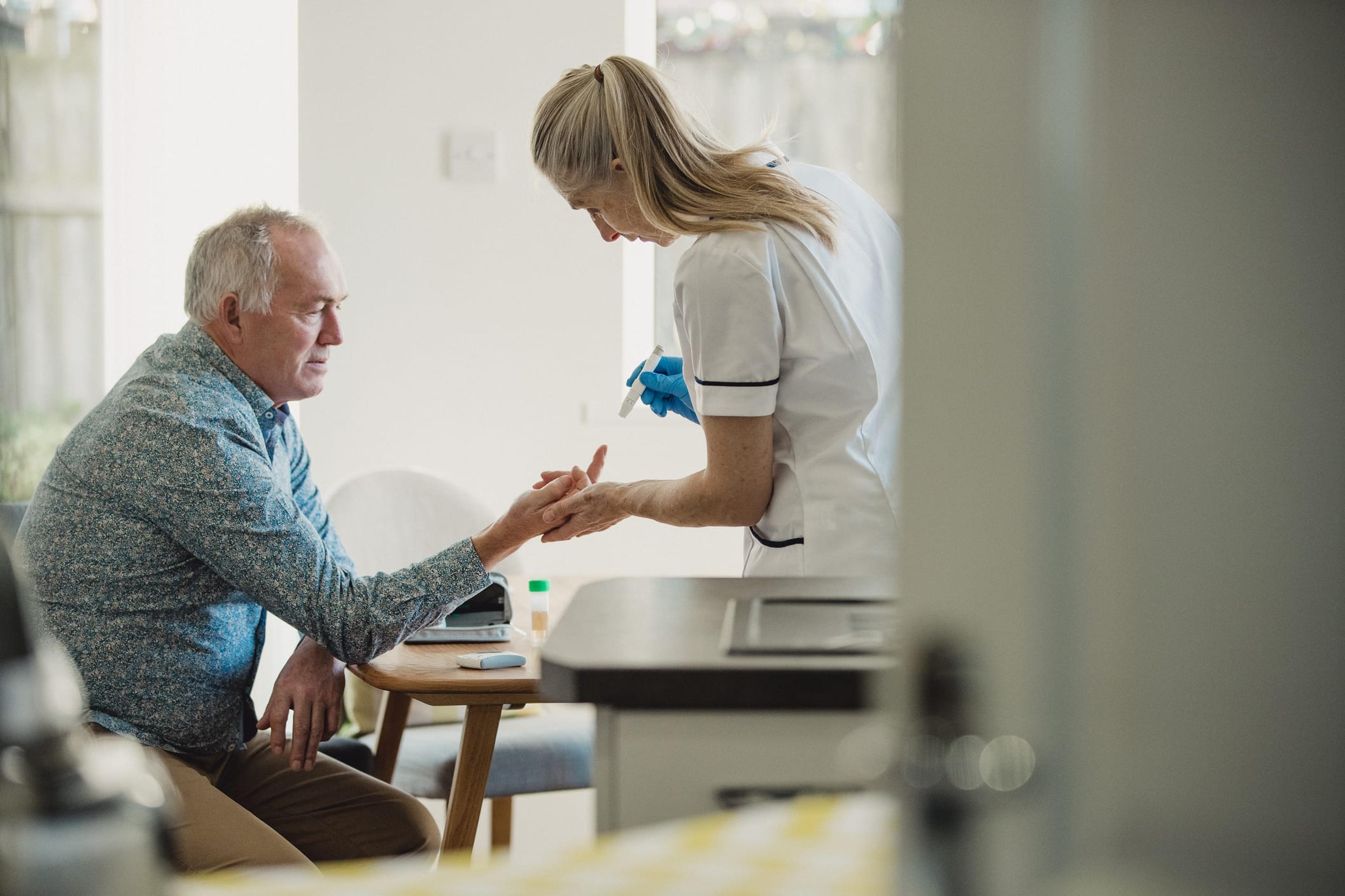 An older man testing his blood sugar