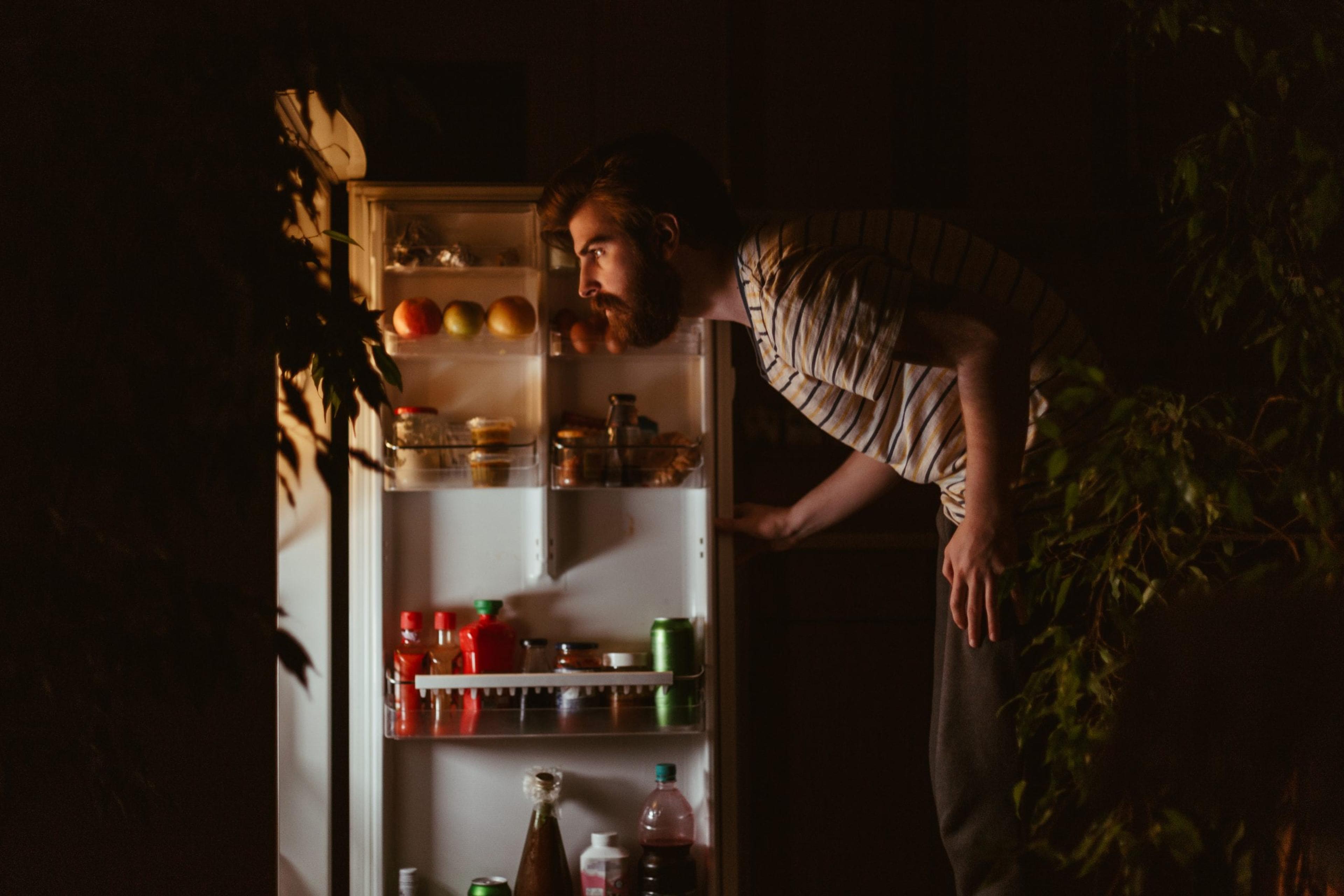 Man looking in his refrigerator