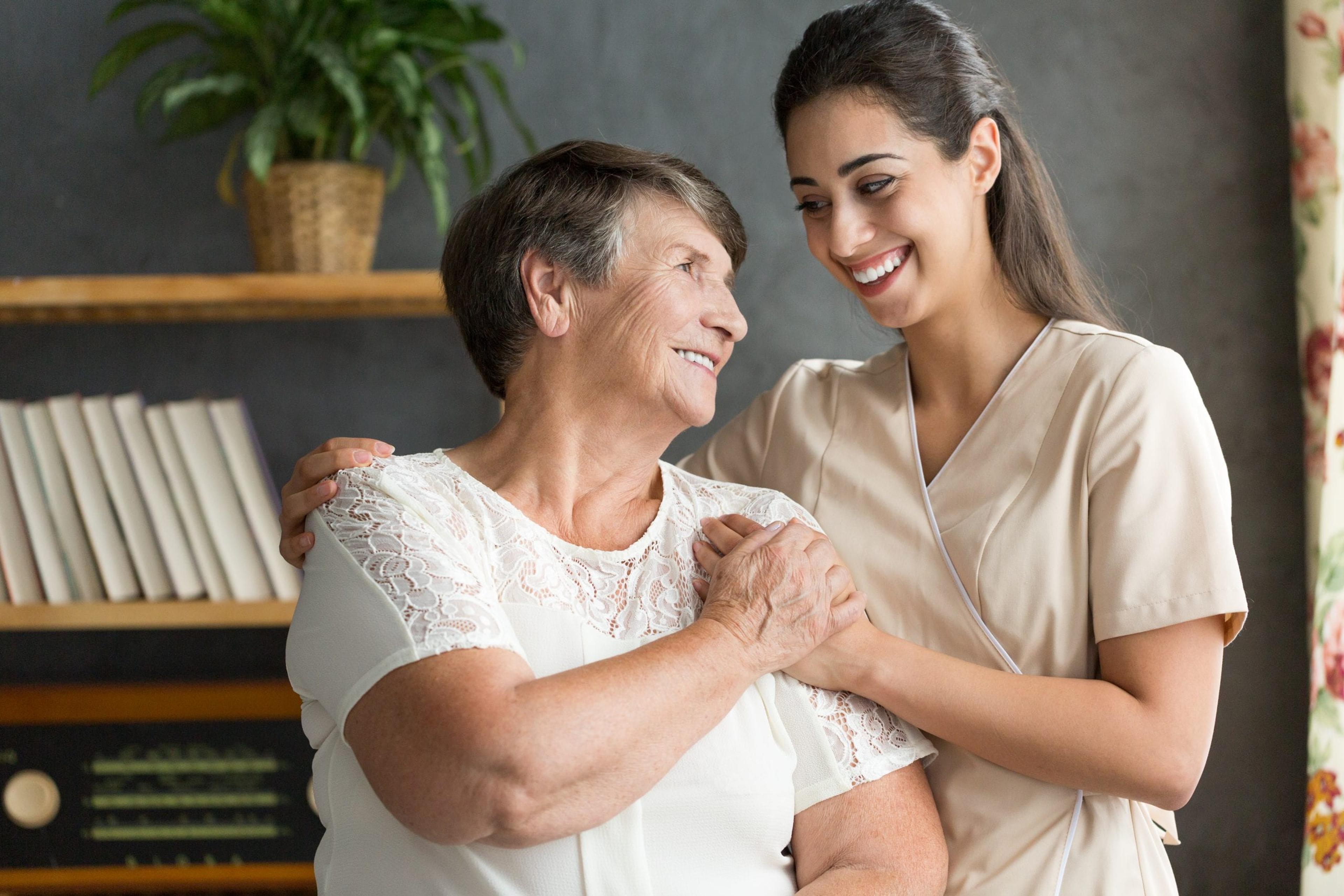 Young woman taking care of elderly woman