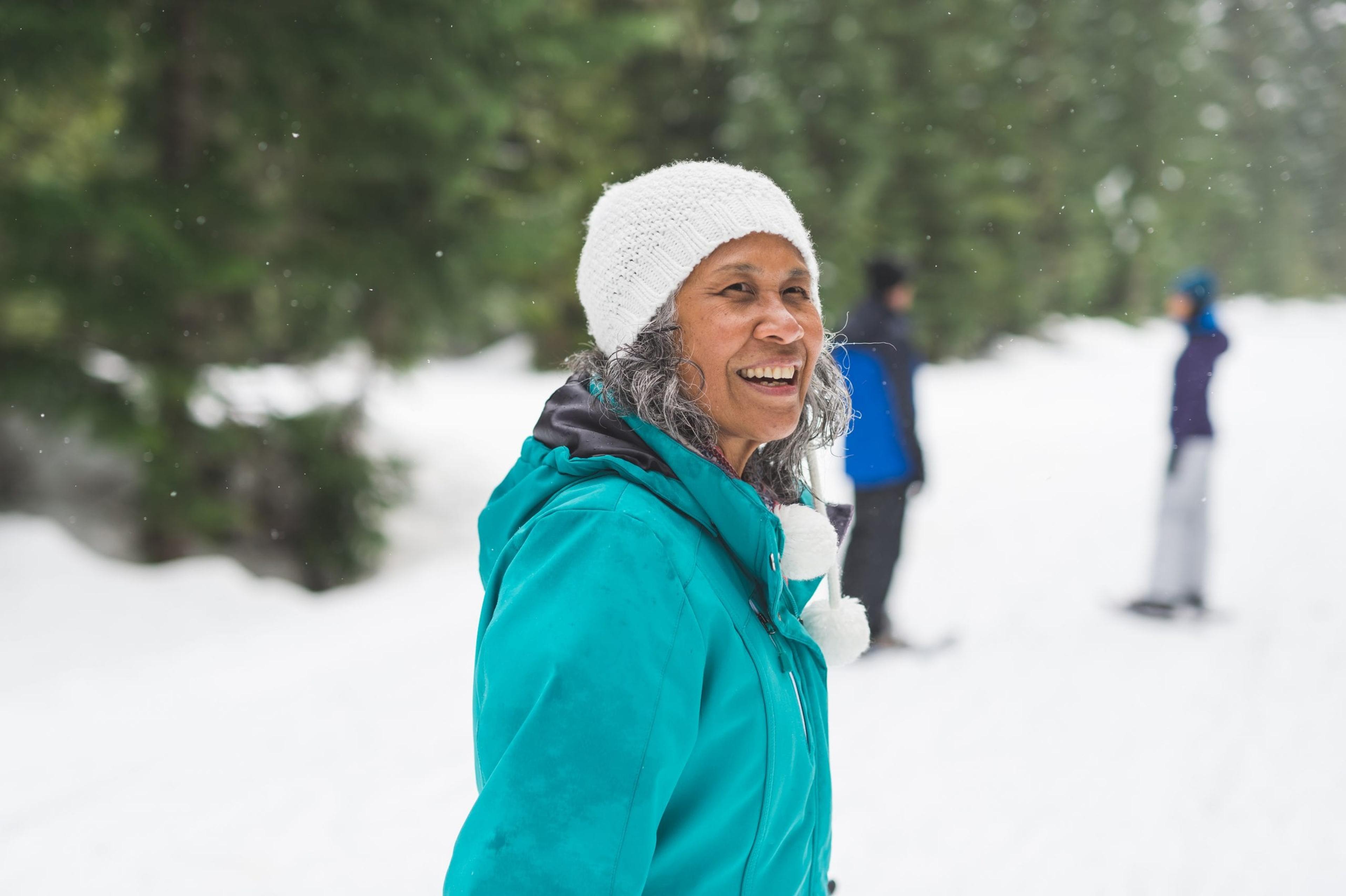Older woman enjoying the snow.