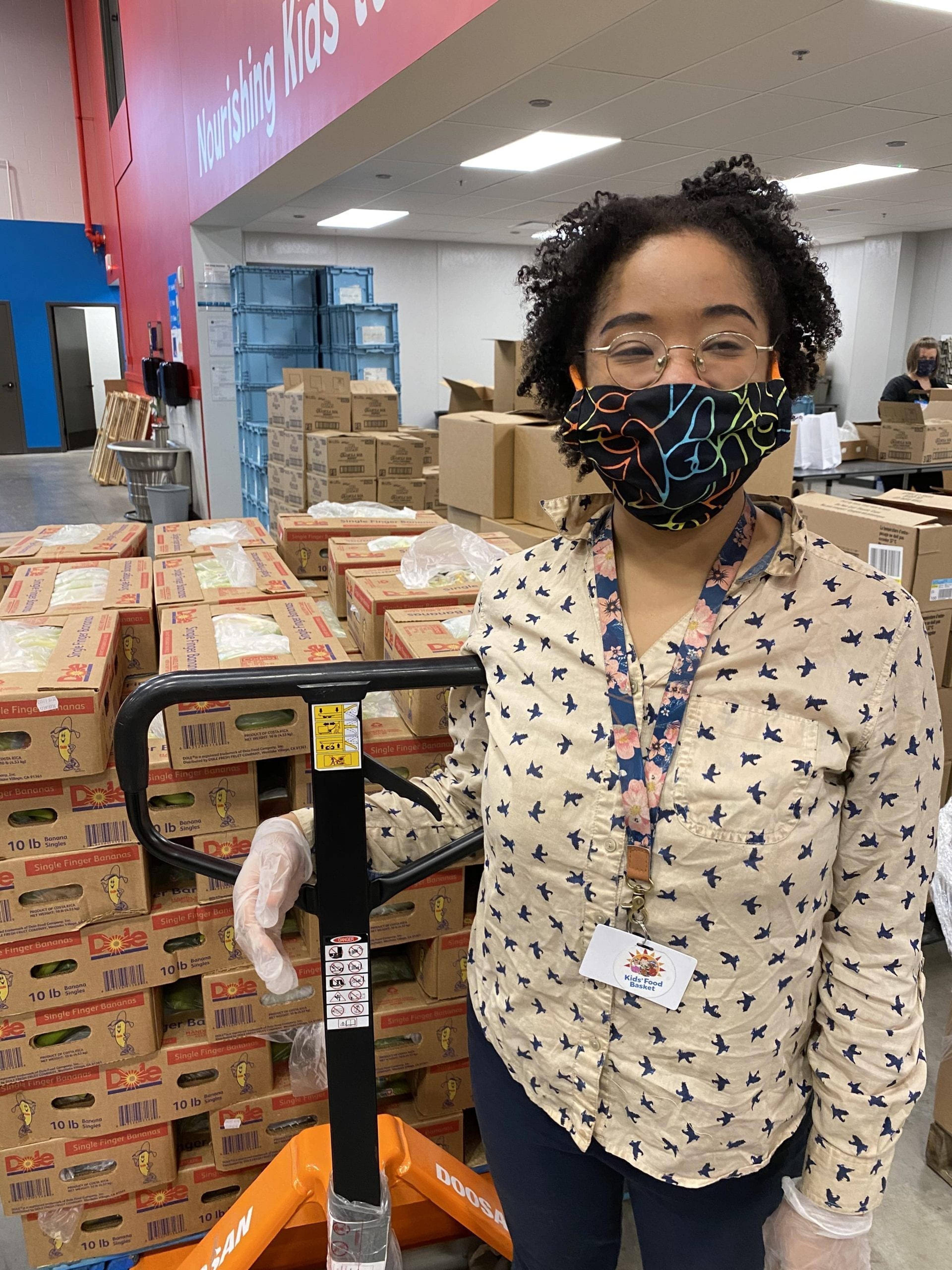 Worker wearing a mask at Kids' Food Basket