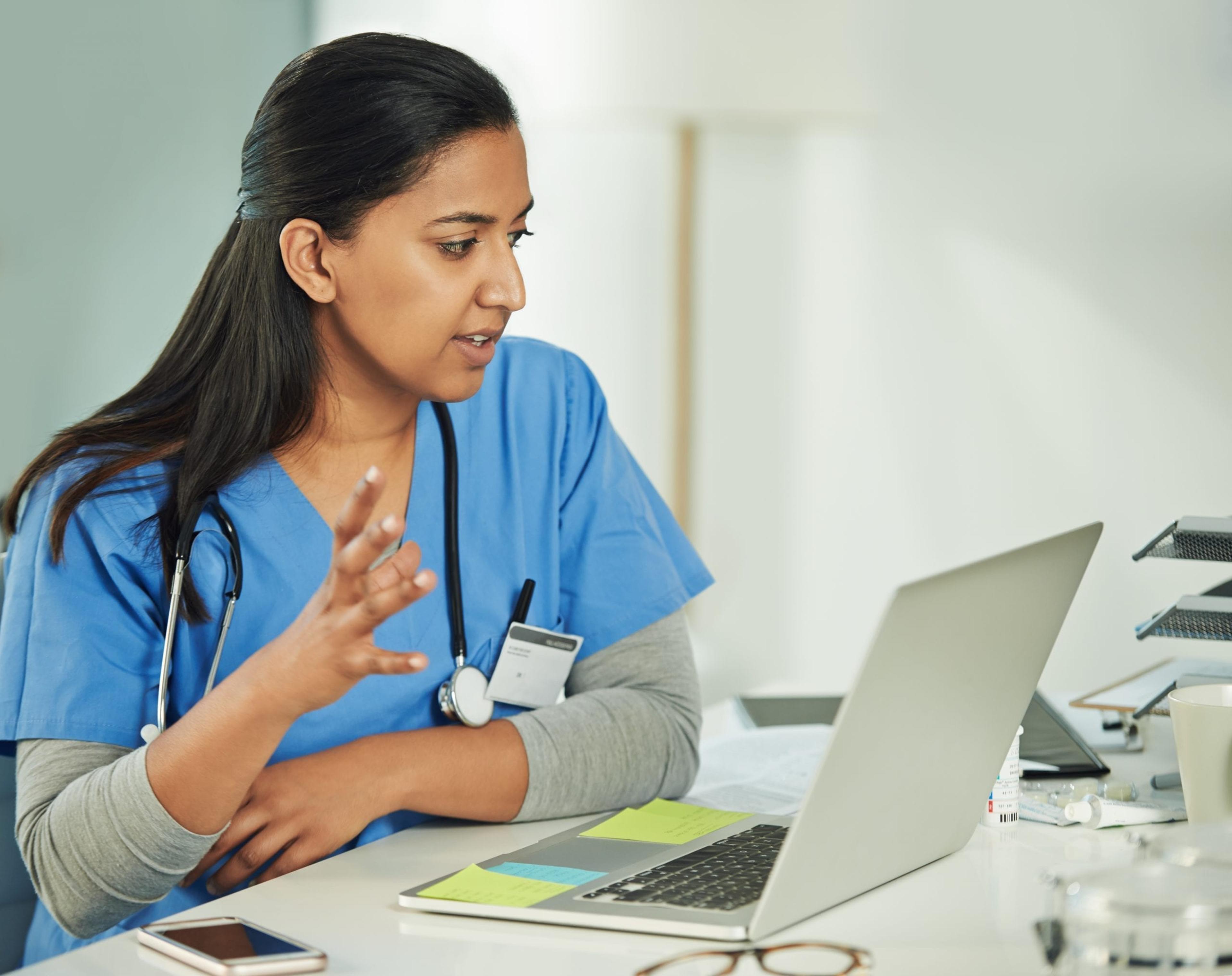 Medical professional talking to patient through a computer