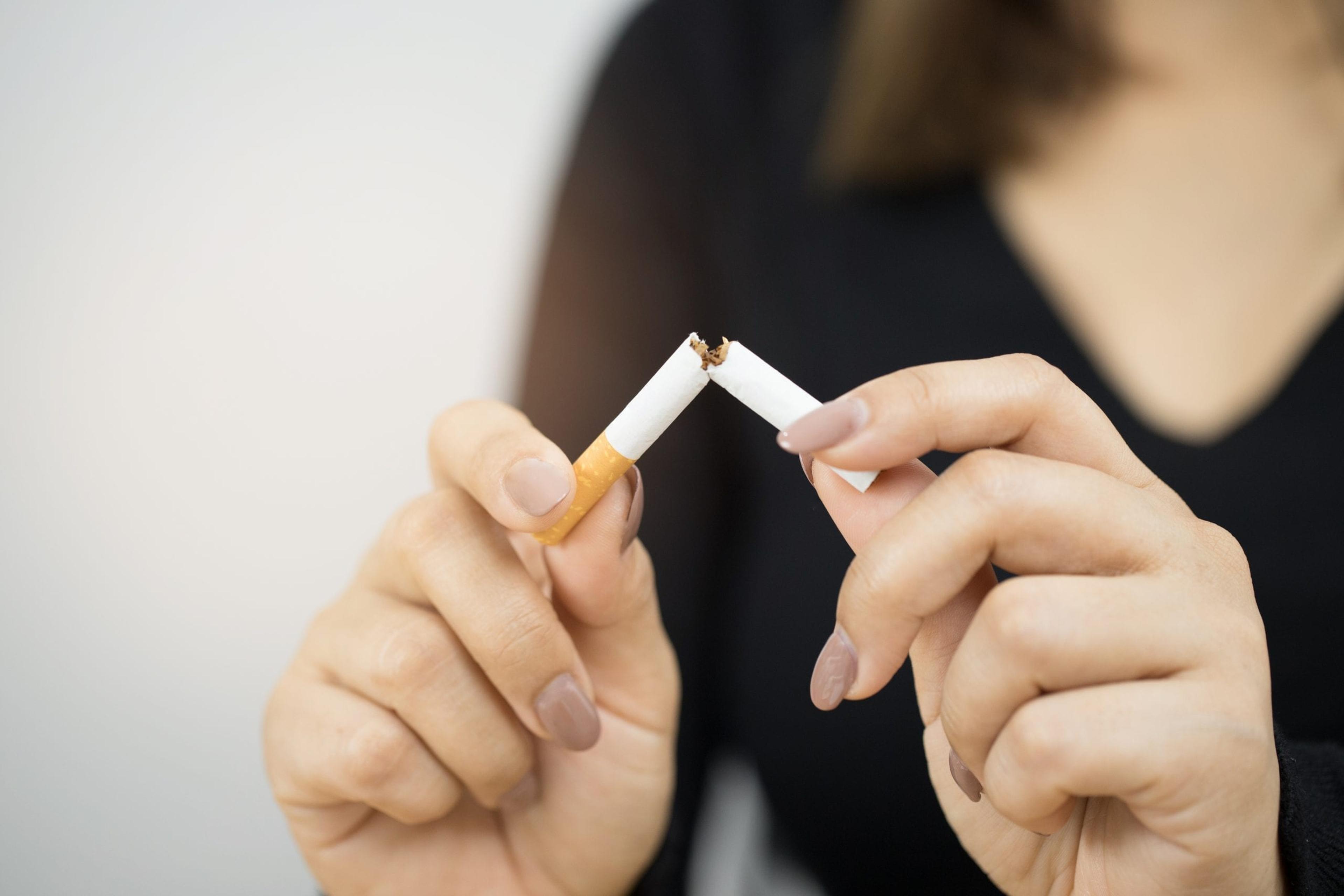 Woman breaking a cigarette