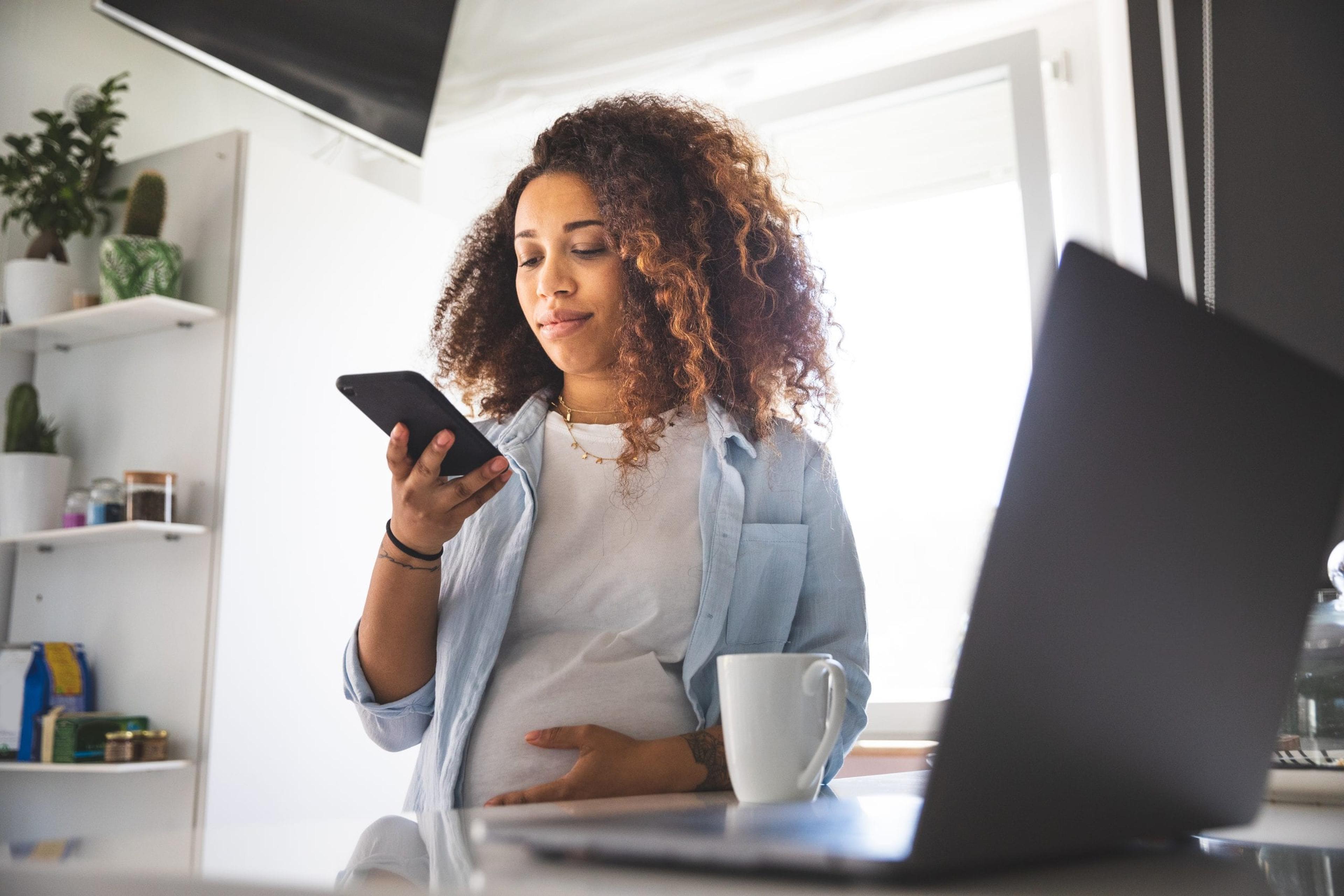 Black Pregnant Woman With Cell Phone