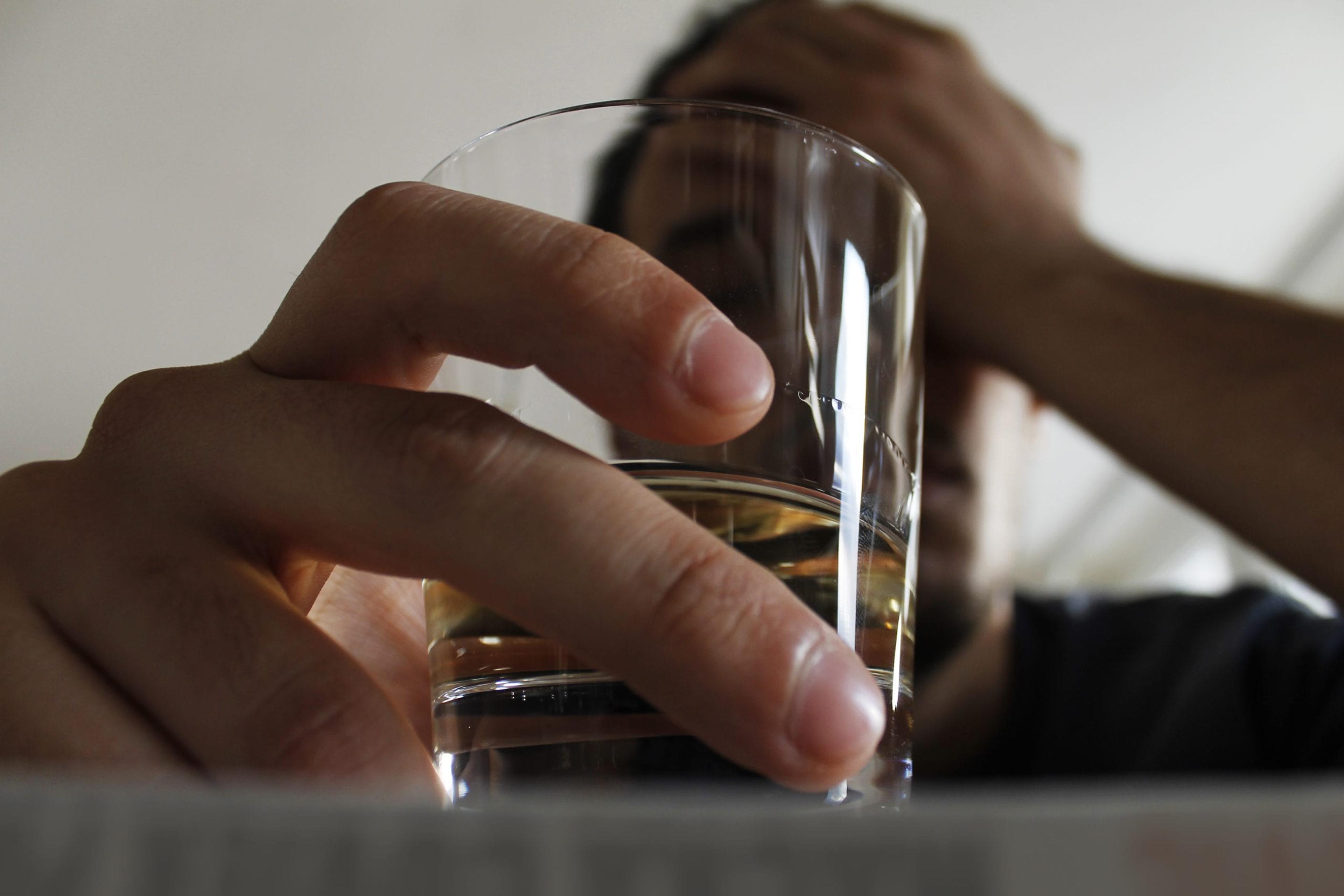 Young adult male holding a drink