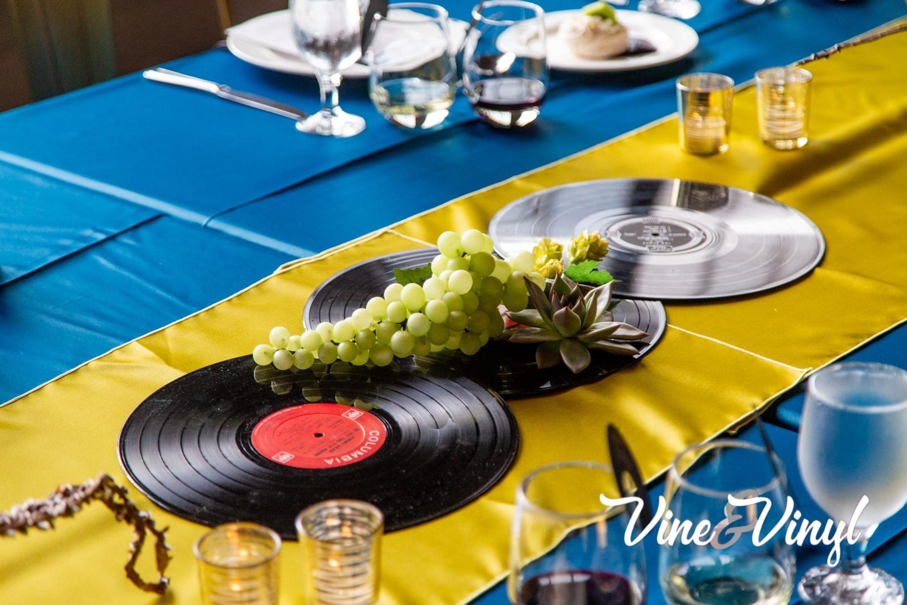 Past Vine & Vinyl centerpiece with albums and grapes