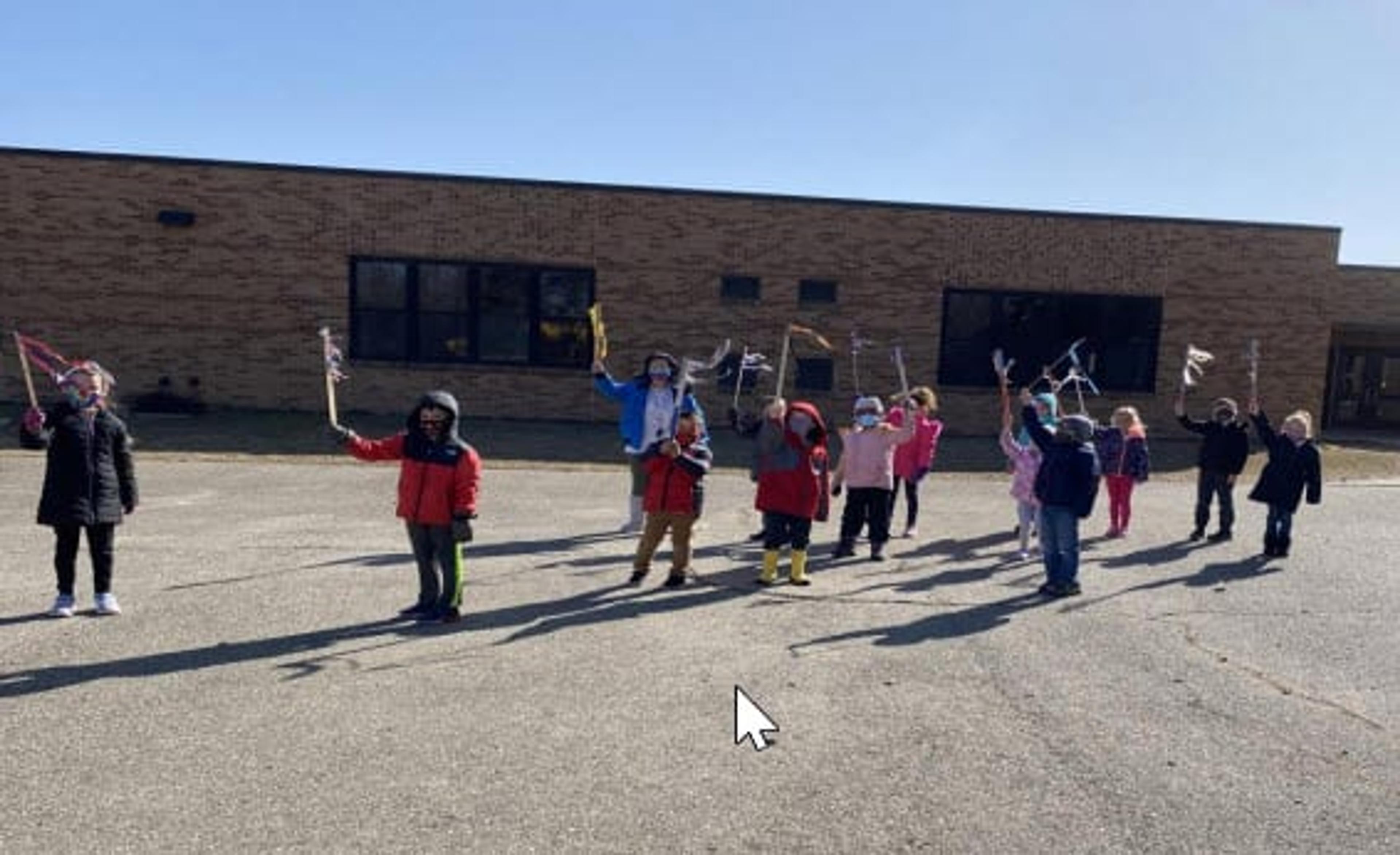 Marcie Bensman playing outside with some of her students.