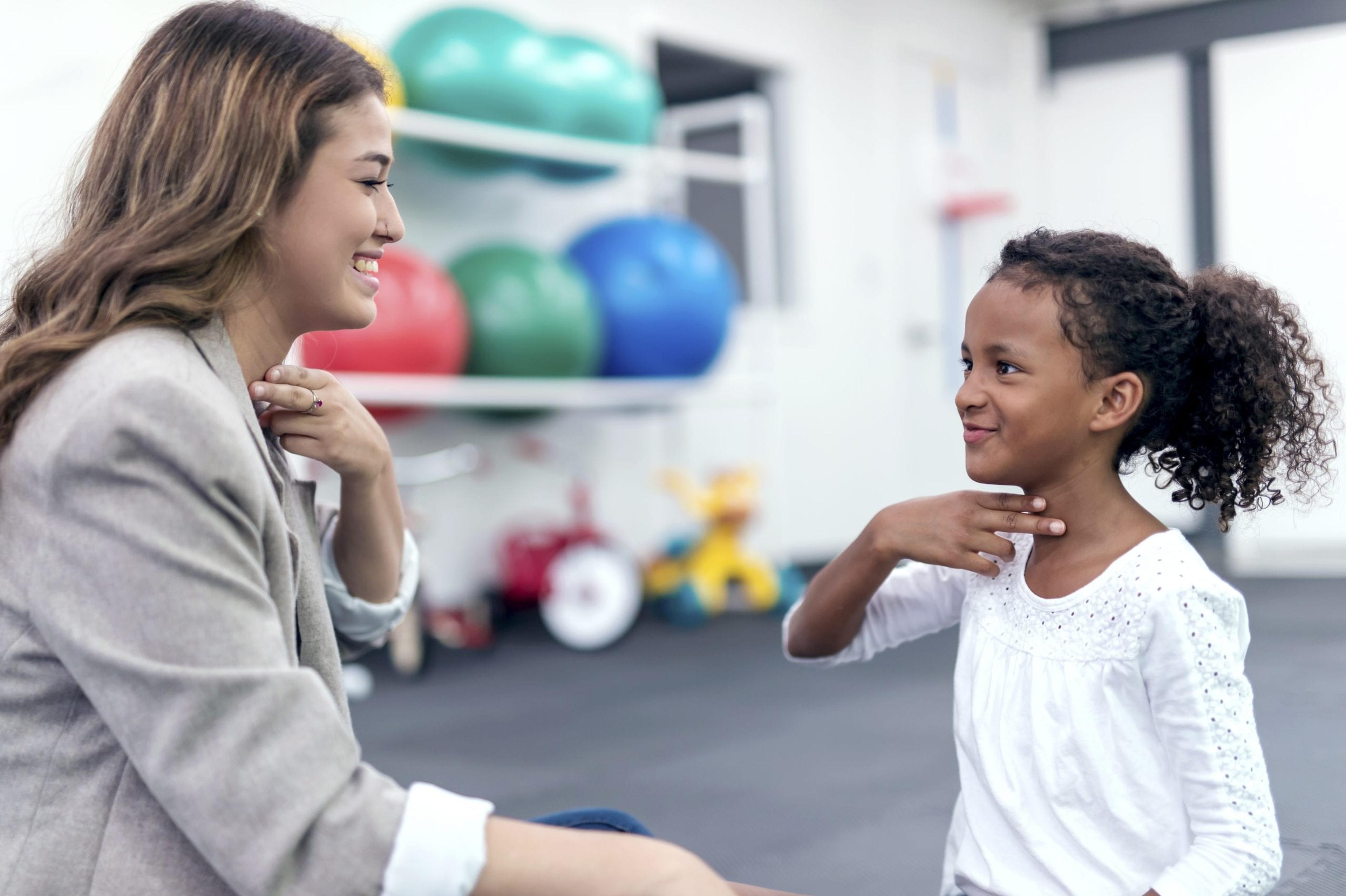 Young girl working with a speech therapist