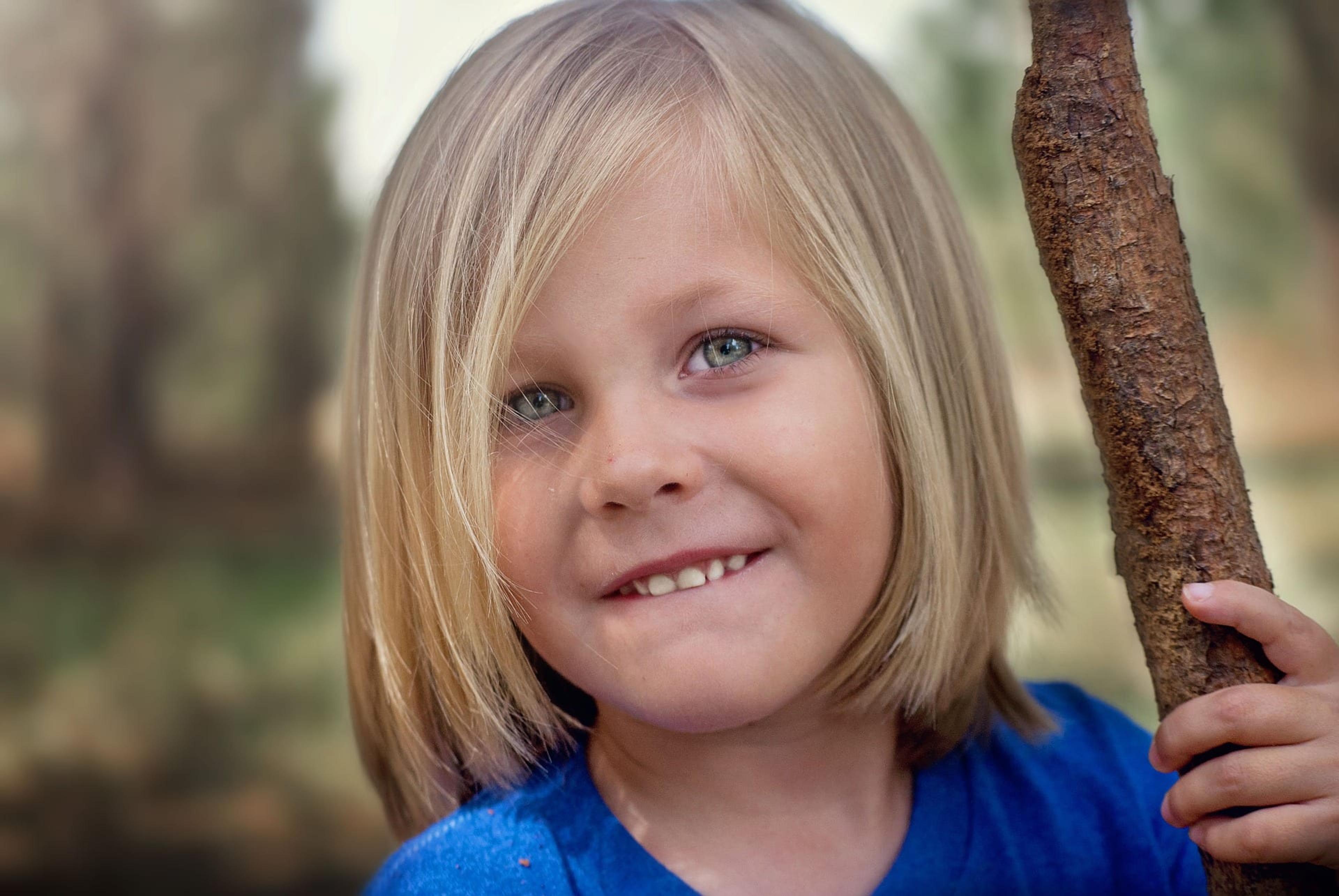 Closeup of a boy with long blonde hair