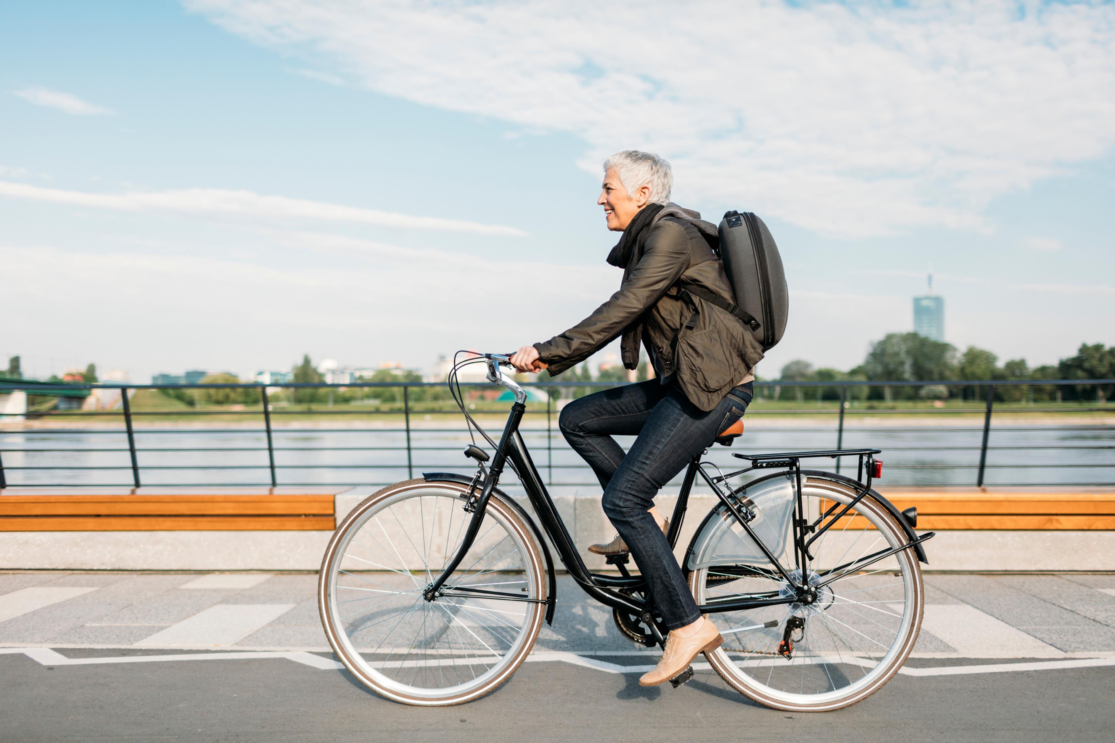 An older woman rides her bicycle to work.