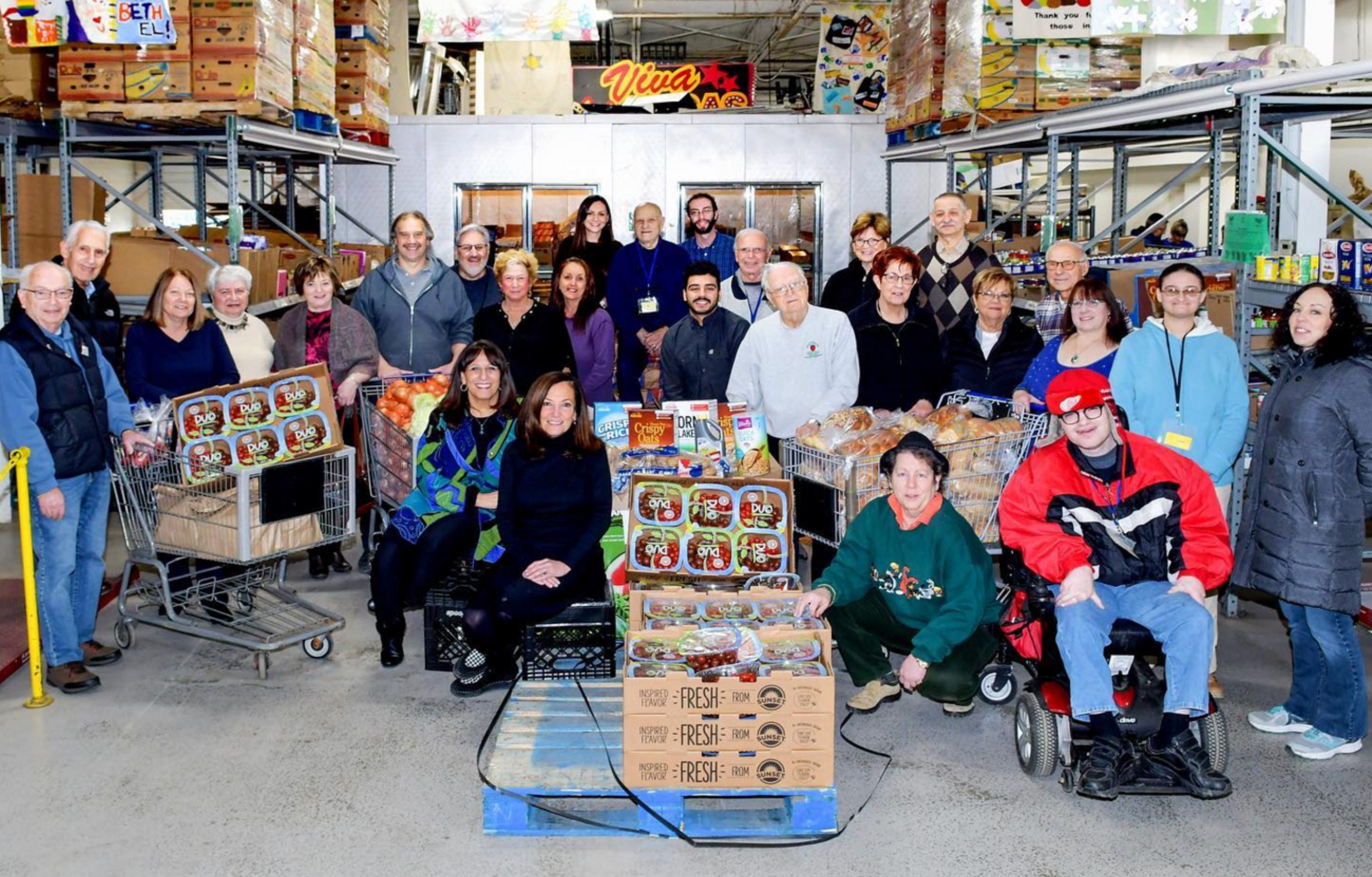 Group photo of Yad Ezra staff in their warehouse