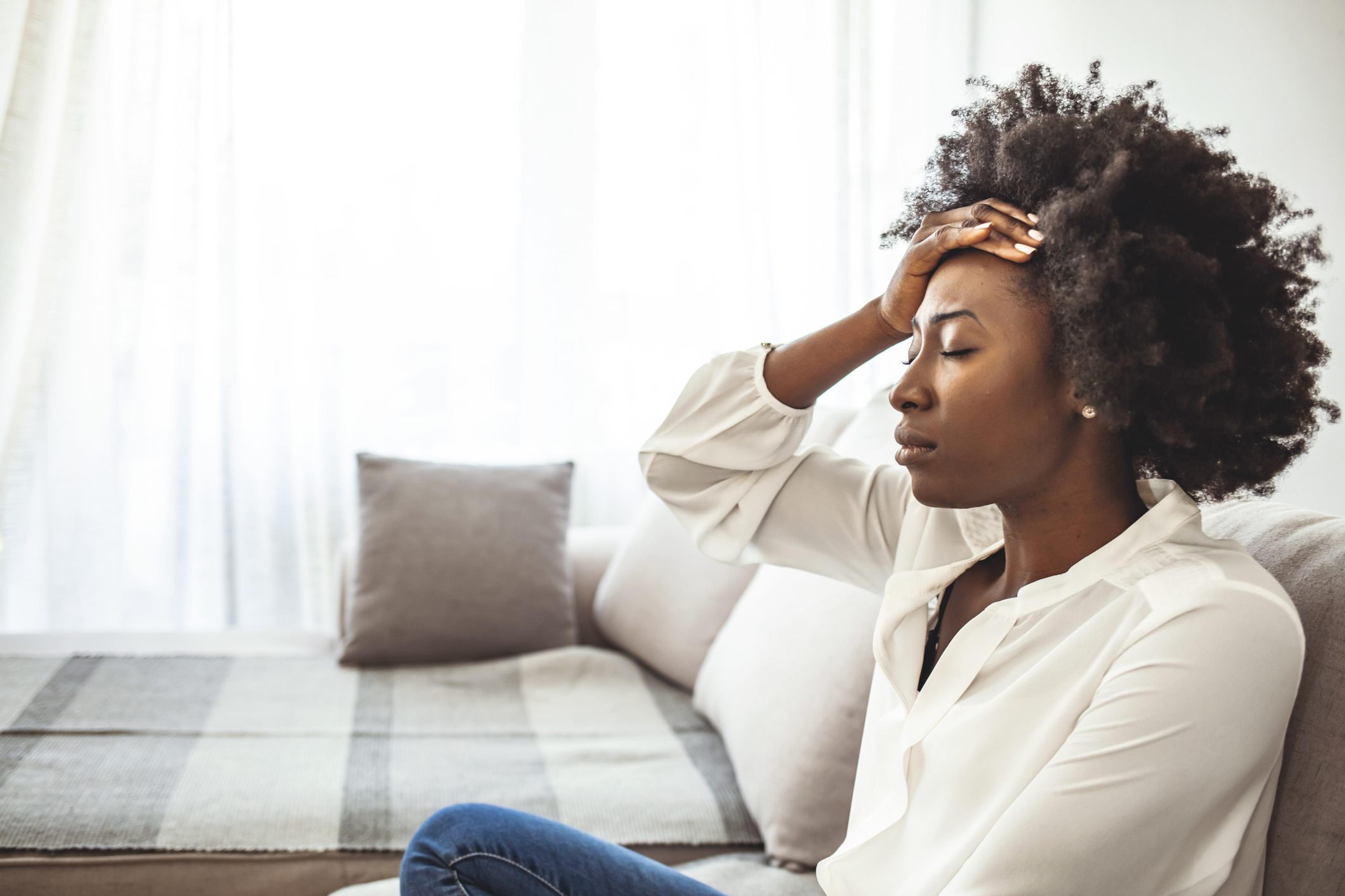 Shot of a young woman suffering from a headache.