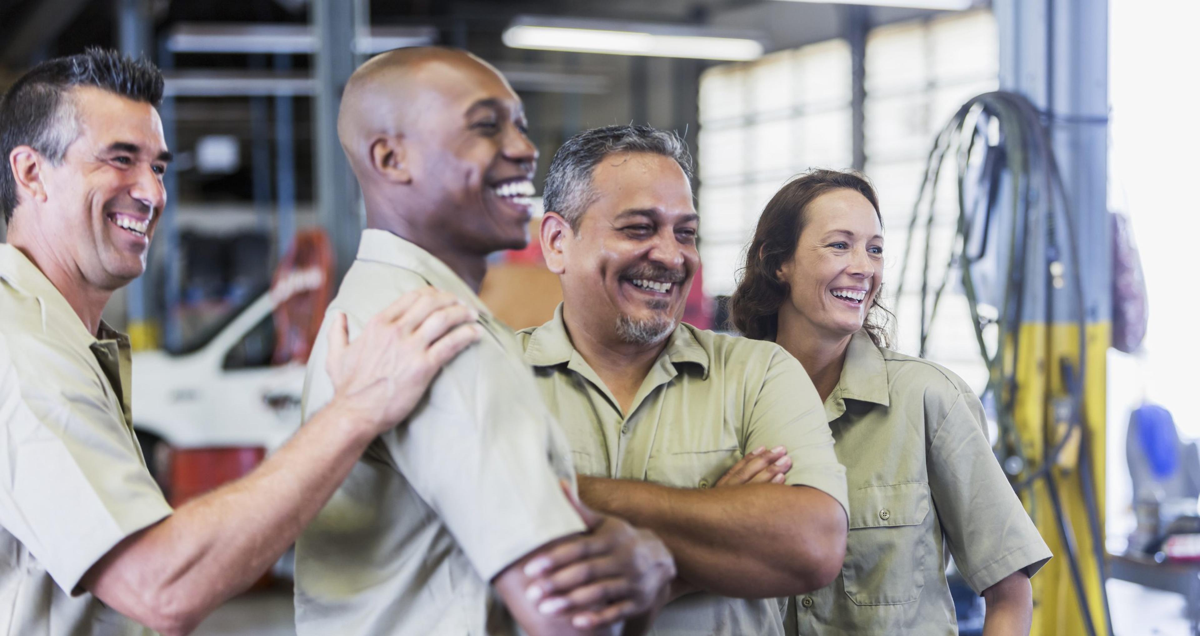 Workers at a small business trucking company gather for a meeting