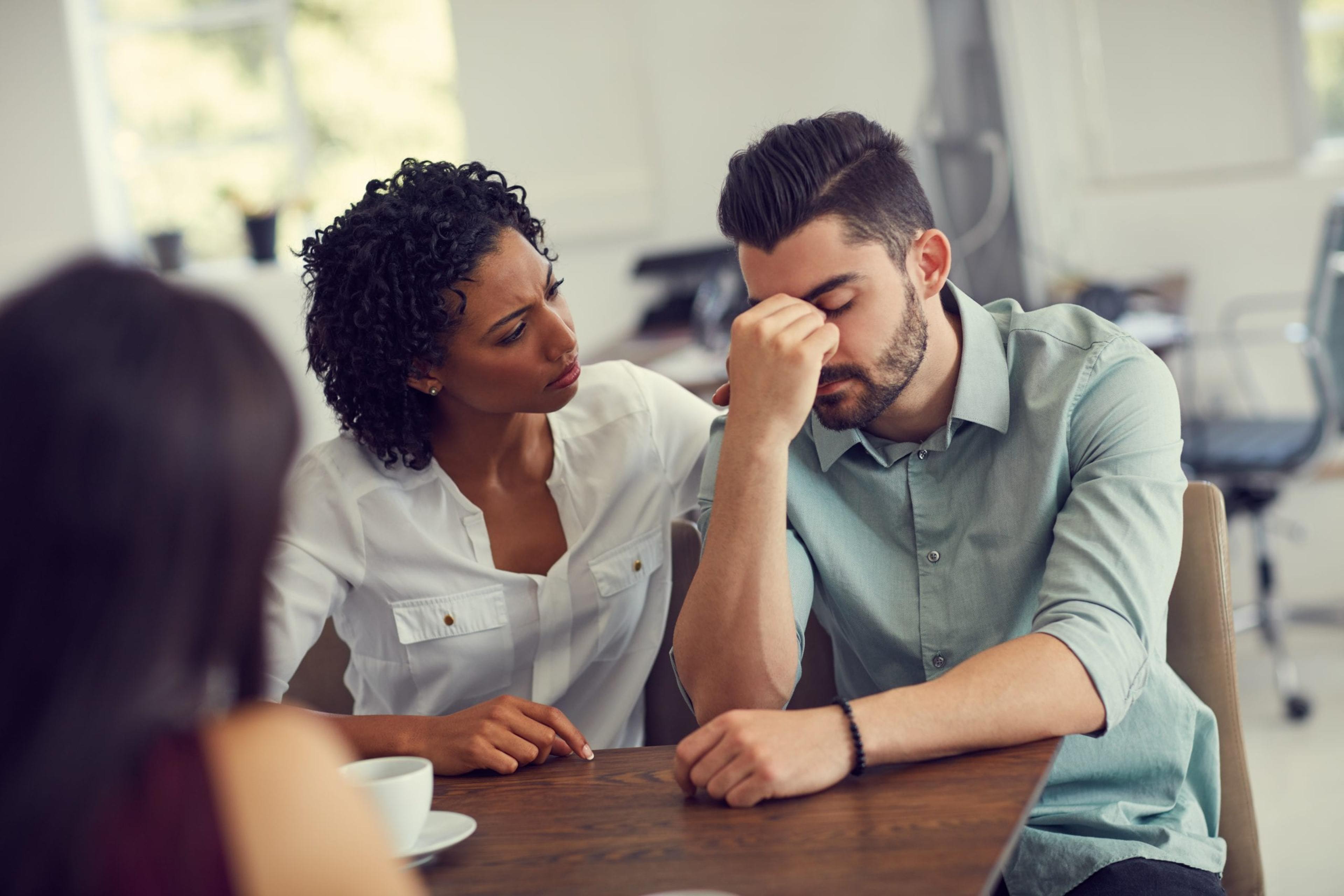 Cropped shot of a wife consoling her husband during a counselling session with a therapist