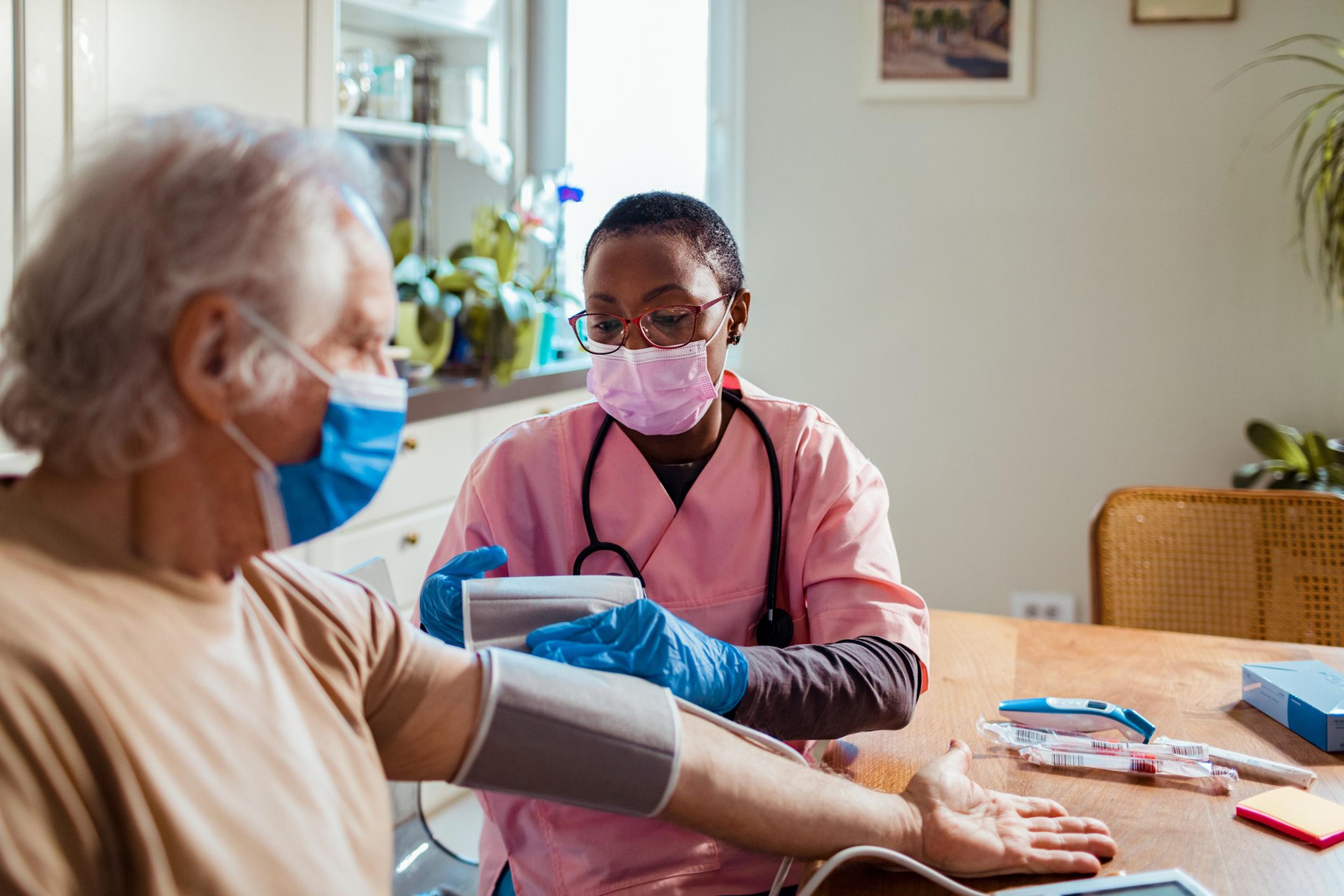 Senior man getting his blood pressure tested by a female nurse