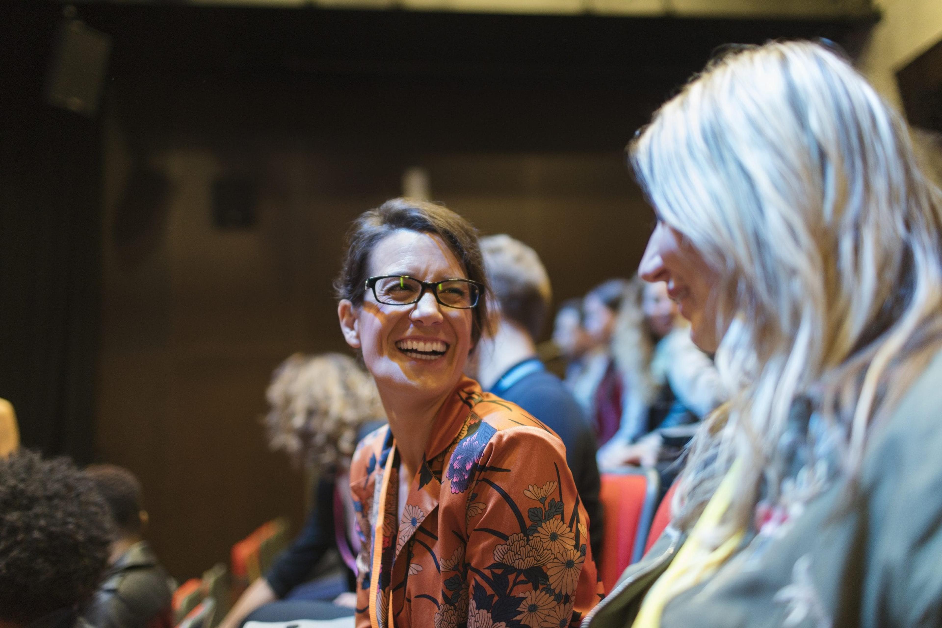 Women talking and laughing at a business conference