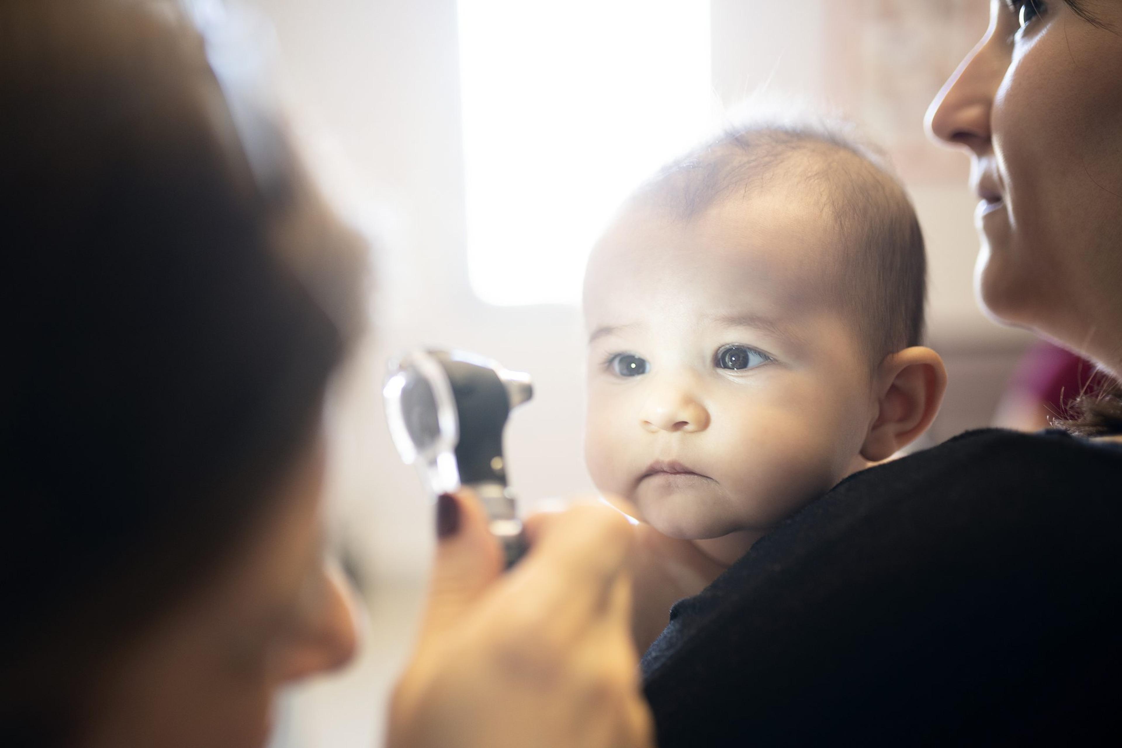 Doctor examines young child for early signs of an eye problem