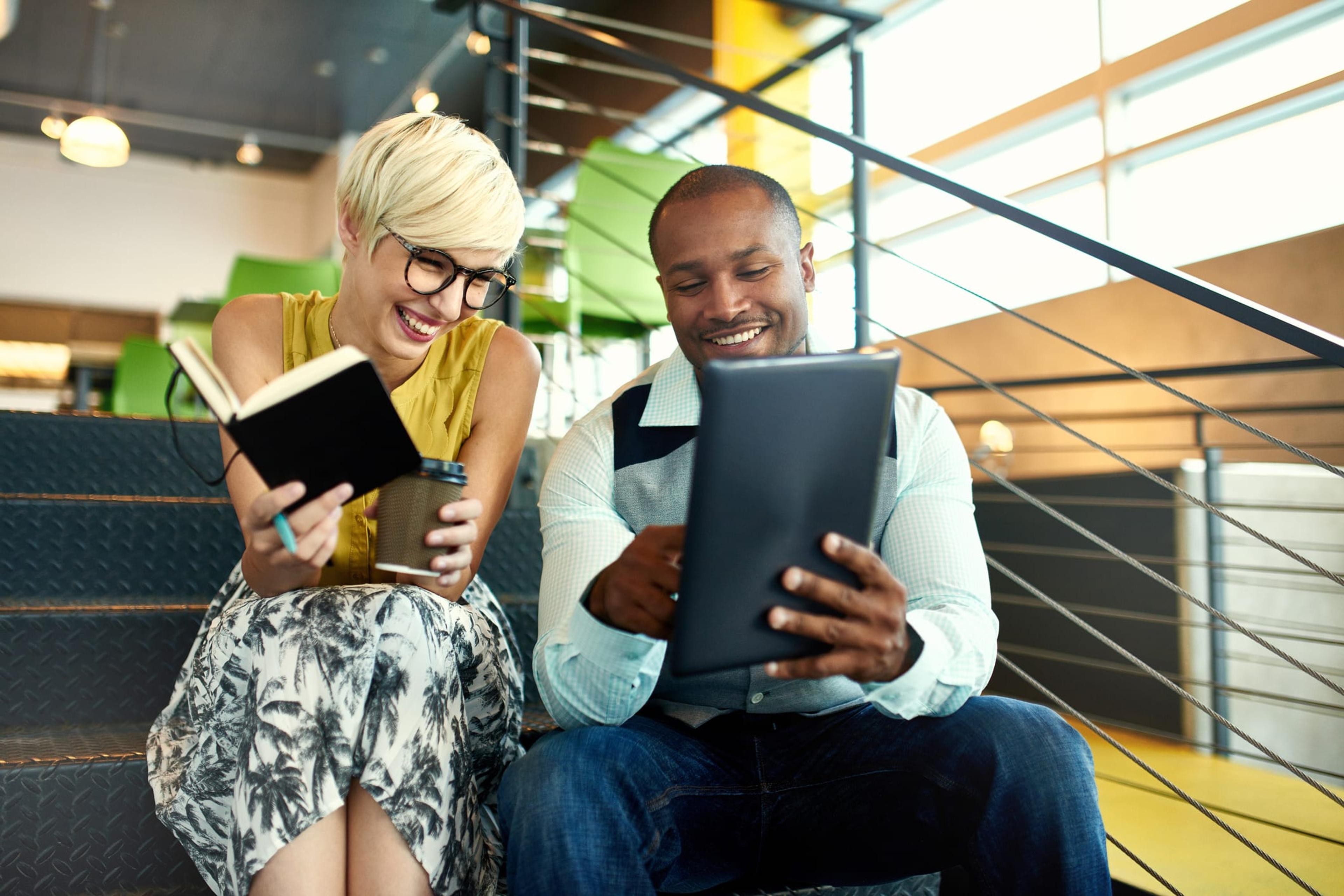 Two young workers collaborating in a modern workspace.