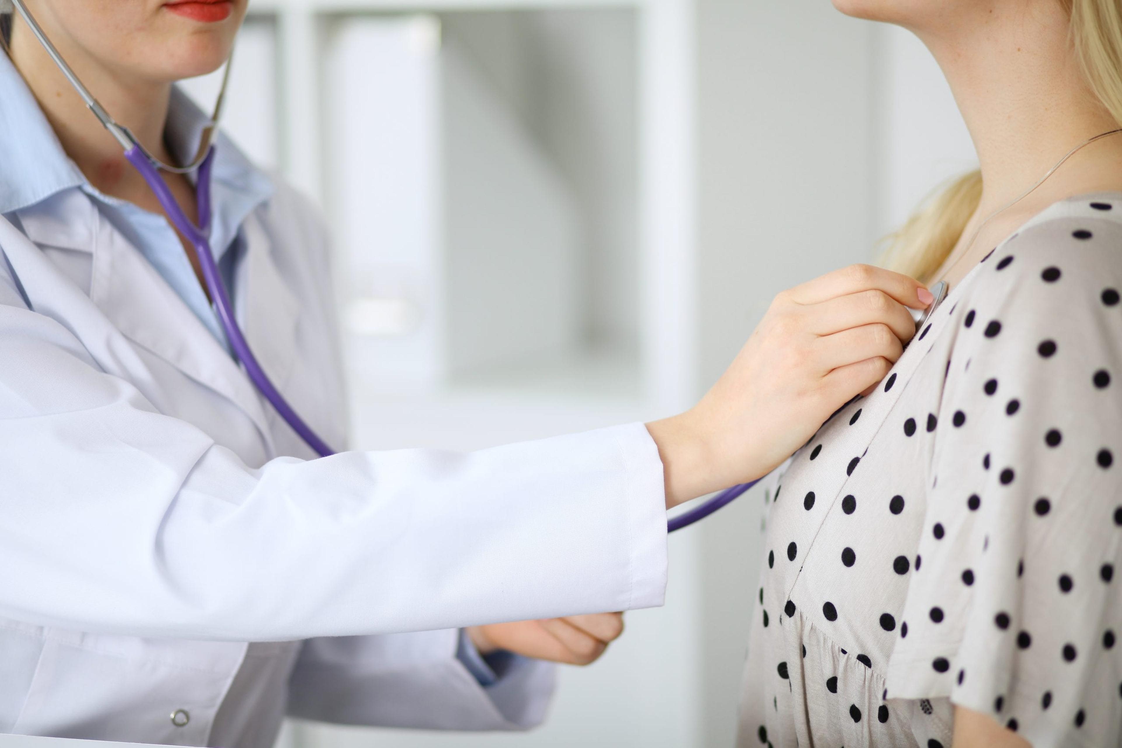 Doctor examines a patient with a stethoscope.