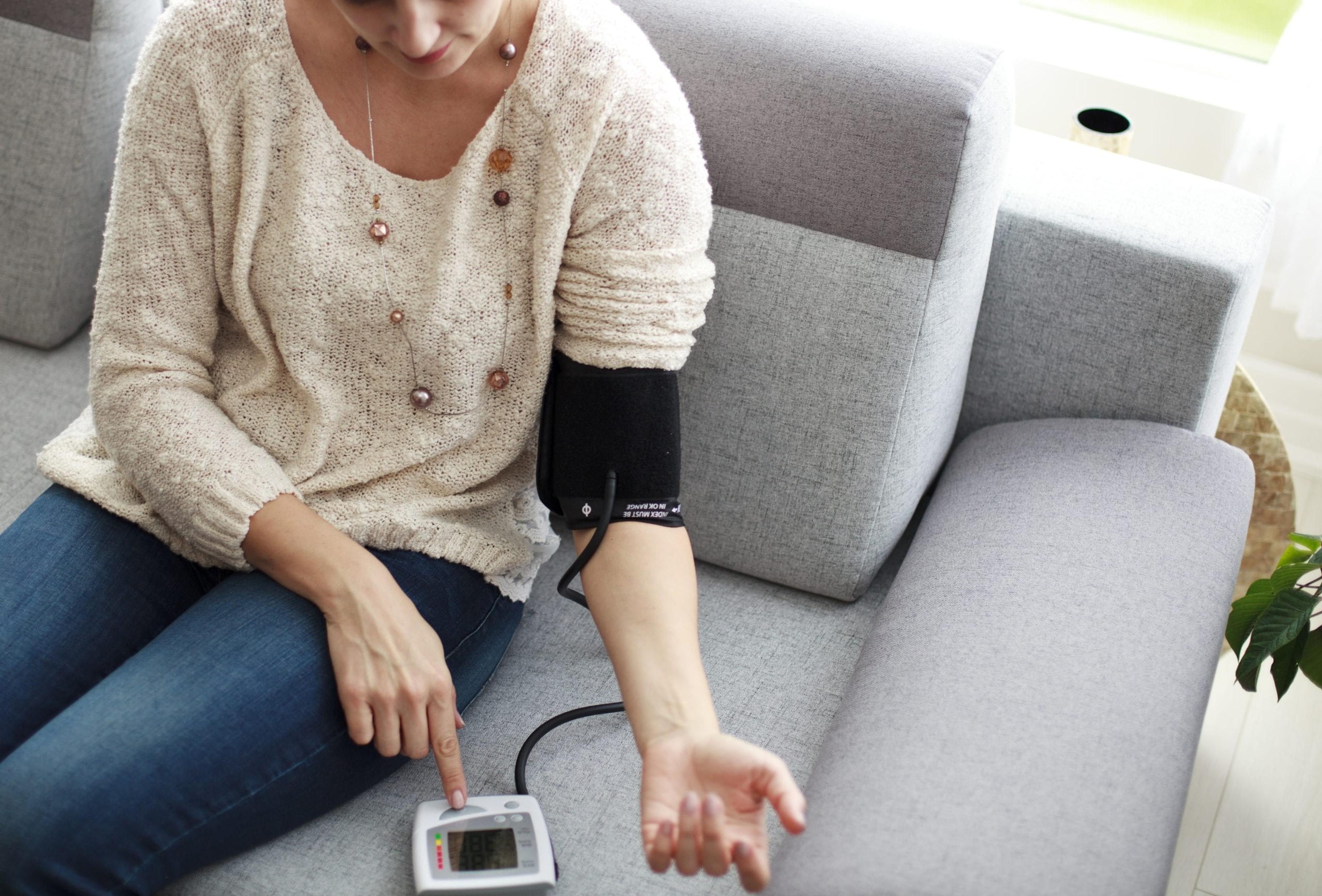 Woman taking her own blood pressure