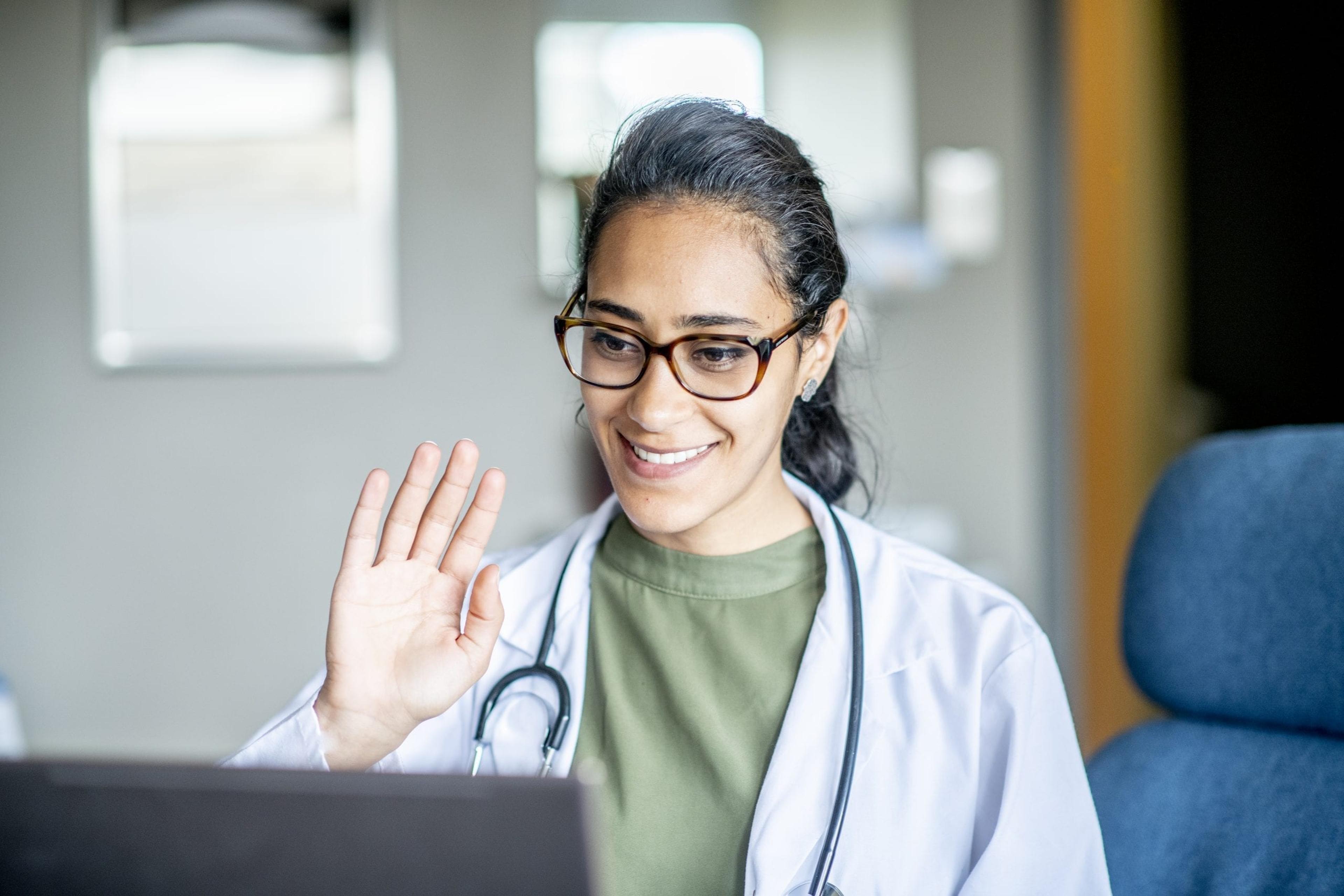 Doctor waving at a virtual patient