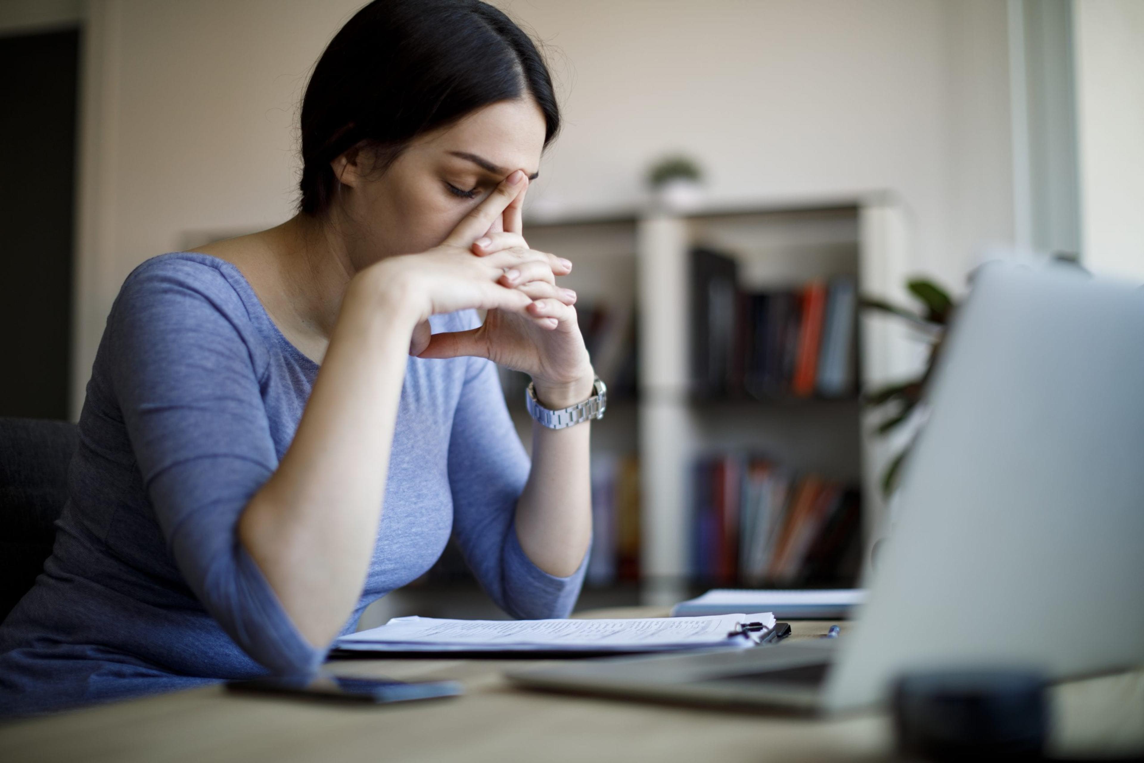 Distressed woman in front of a laptop