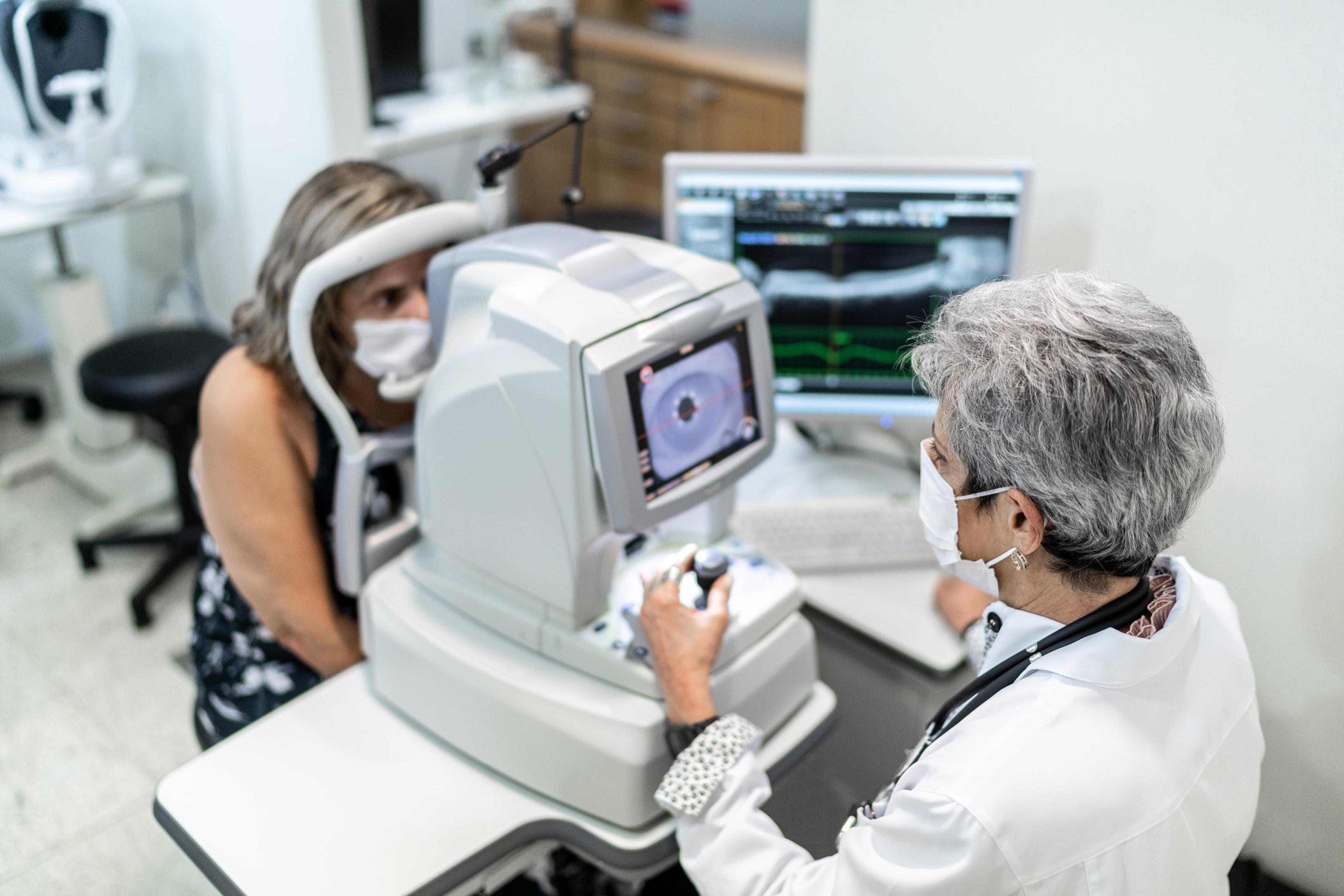 Optometrist examining patient's eyes