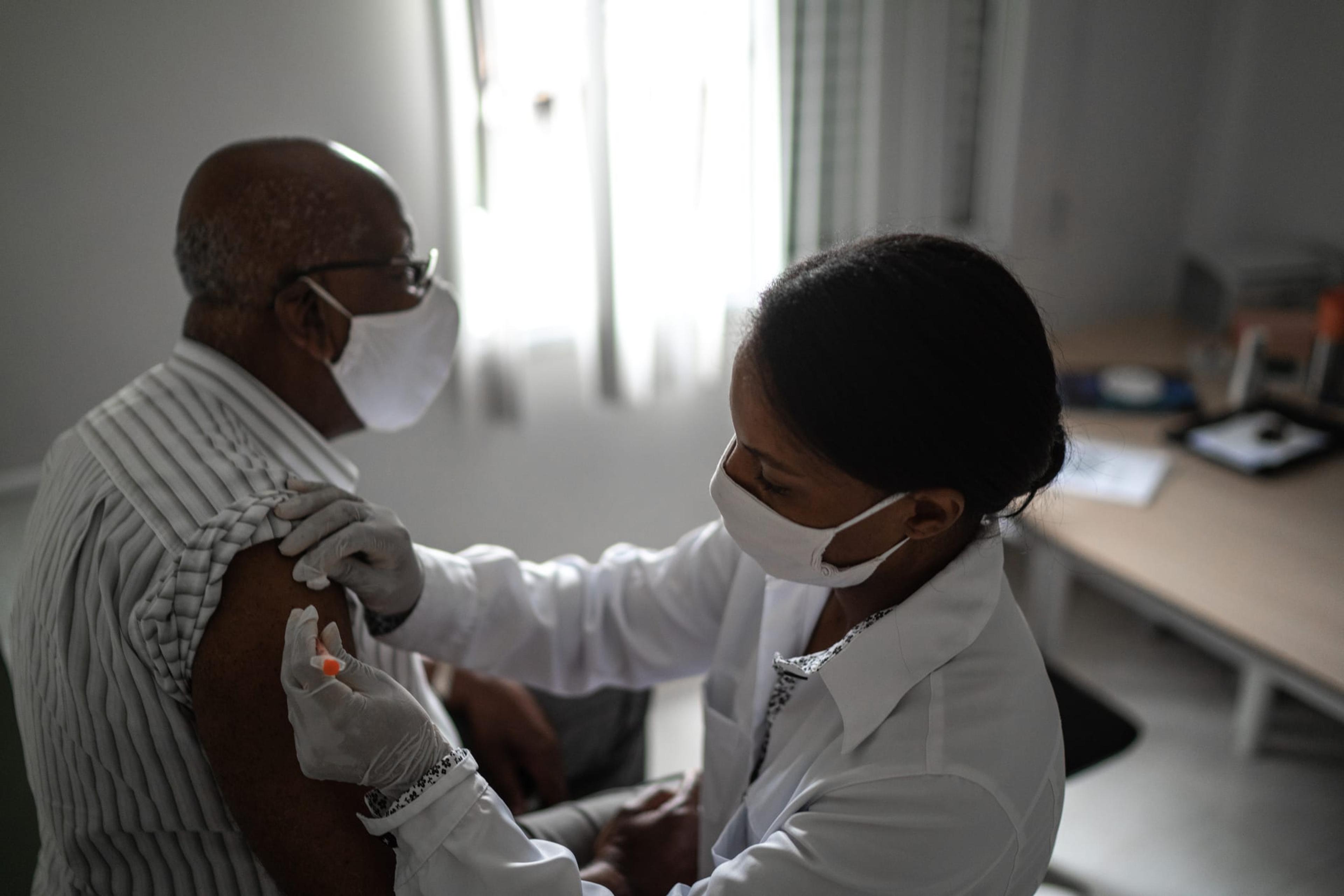 Doctor administers a vaccine to a patient