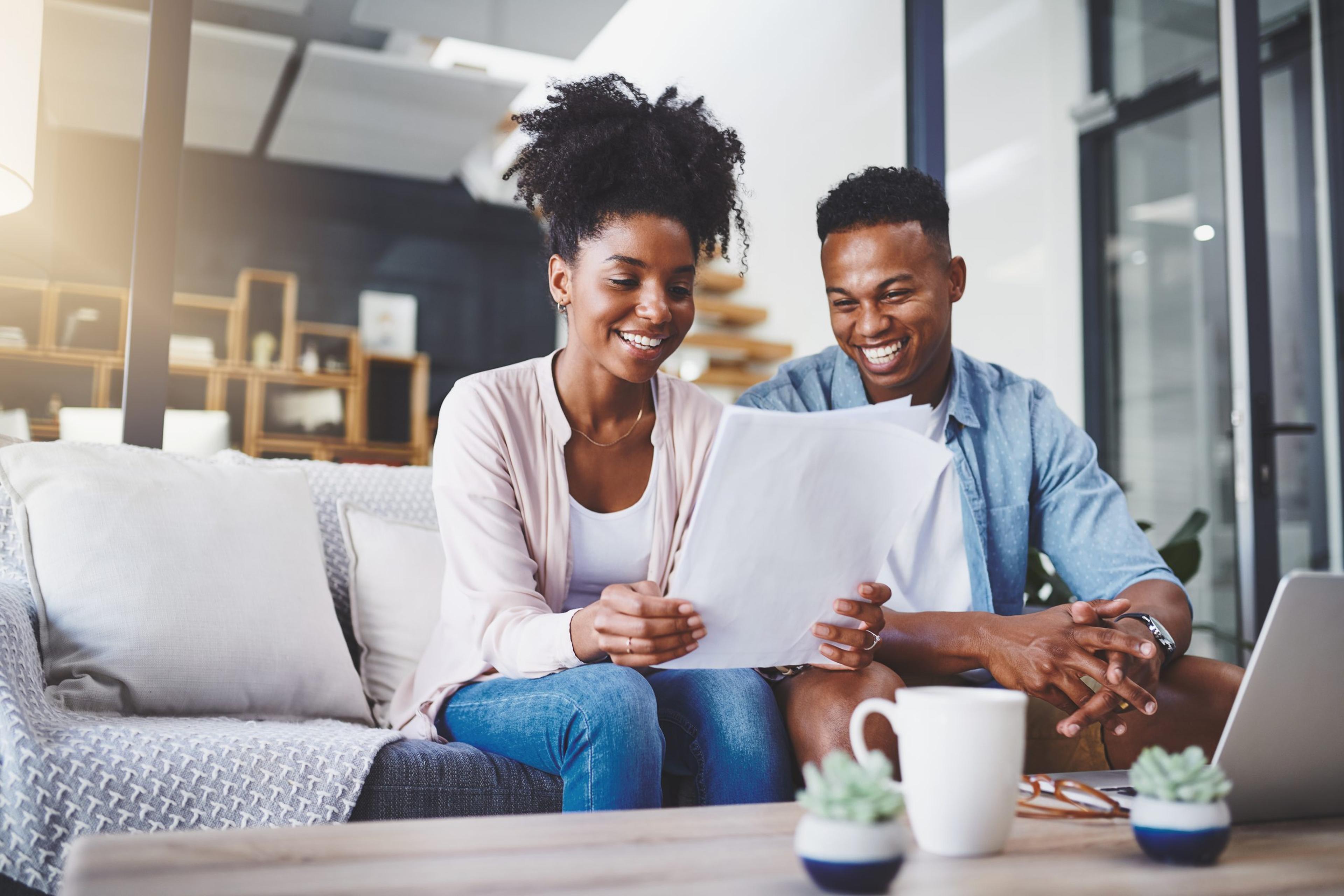 Shot of a young couple going through their paperwork together at home