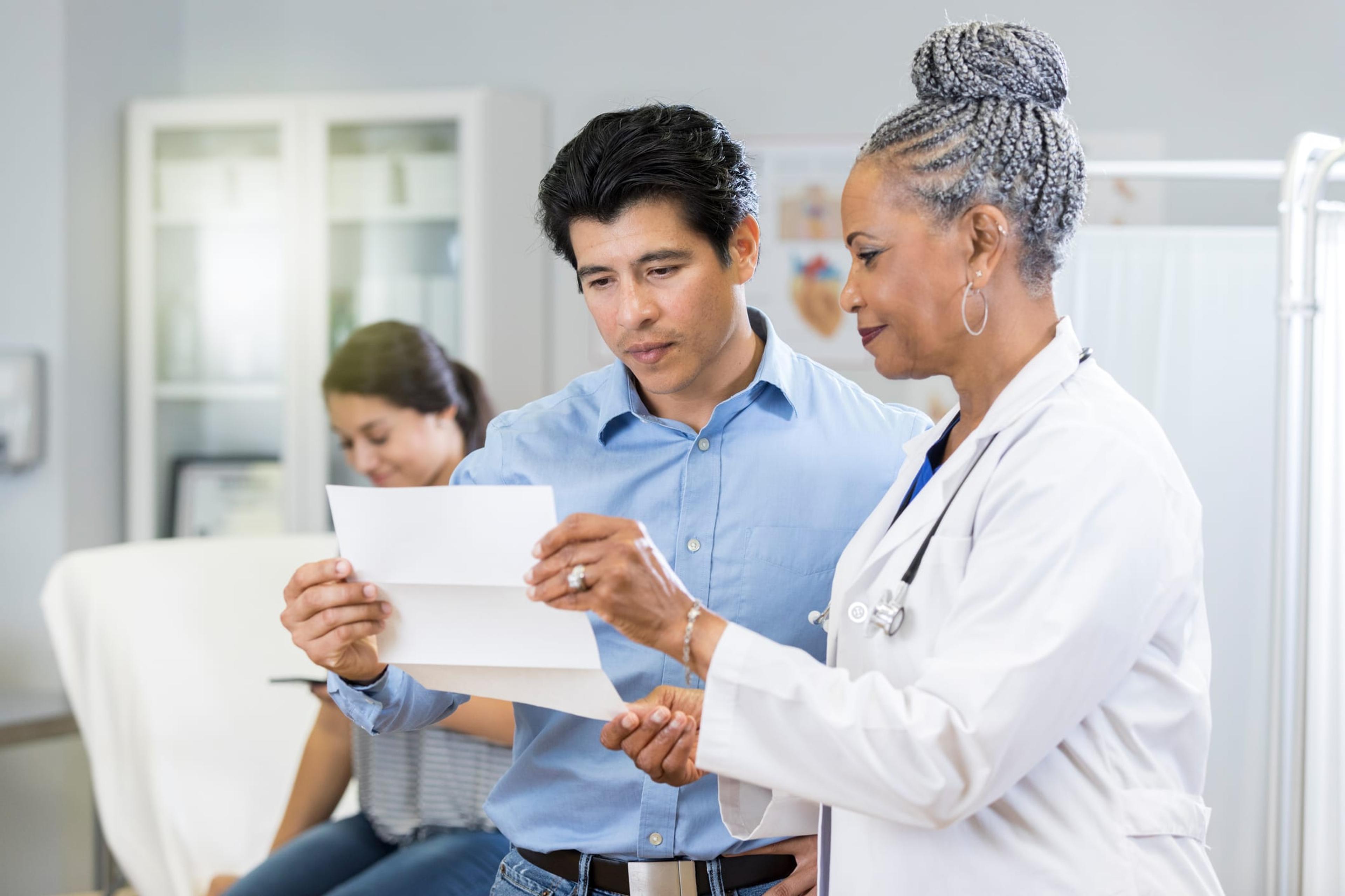 Doctor reviews test results with concerned father