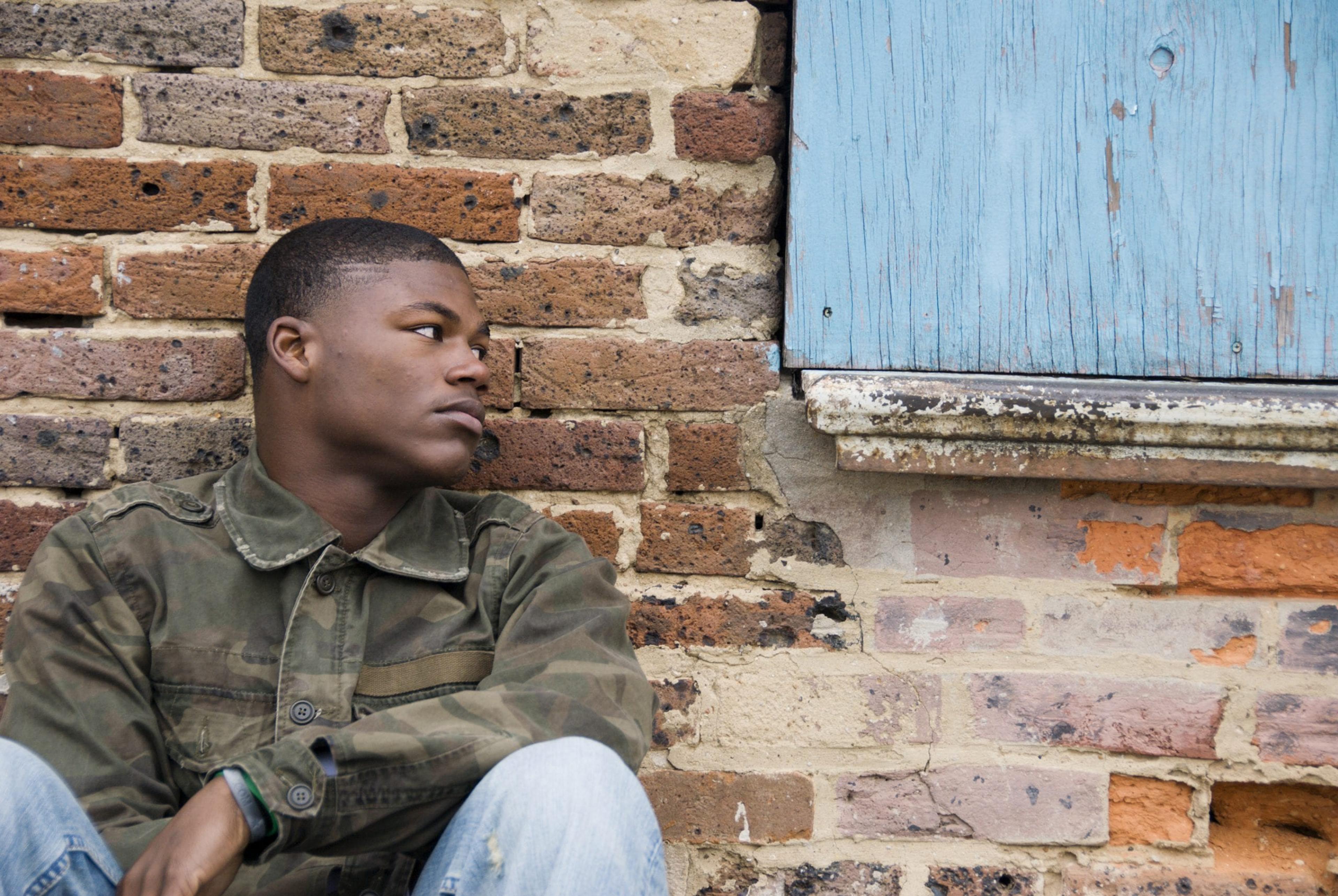 Young man sitting outside