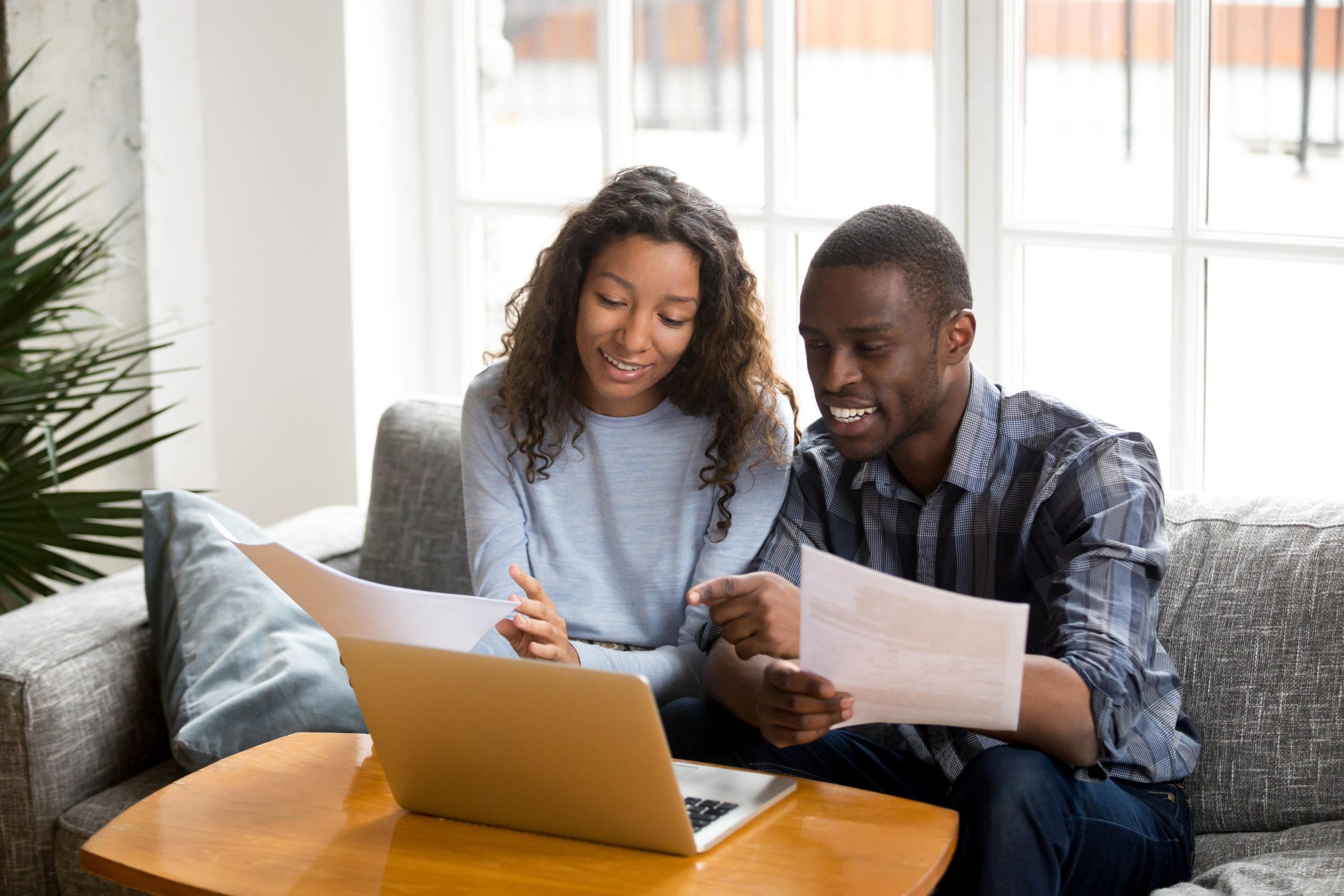 Couple looking at laptop and smiling