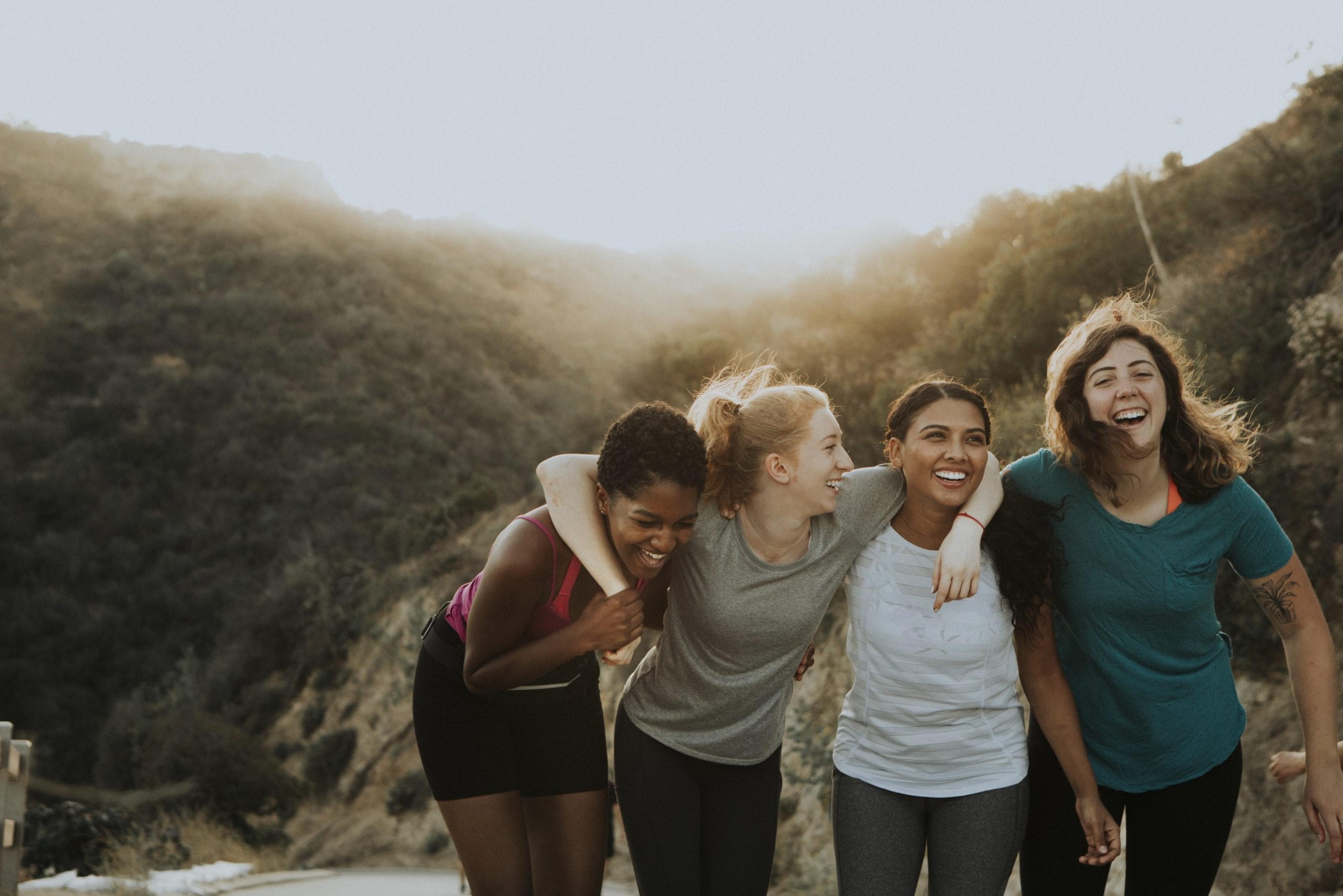 Four young adult women friends hiking