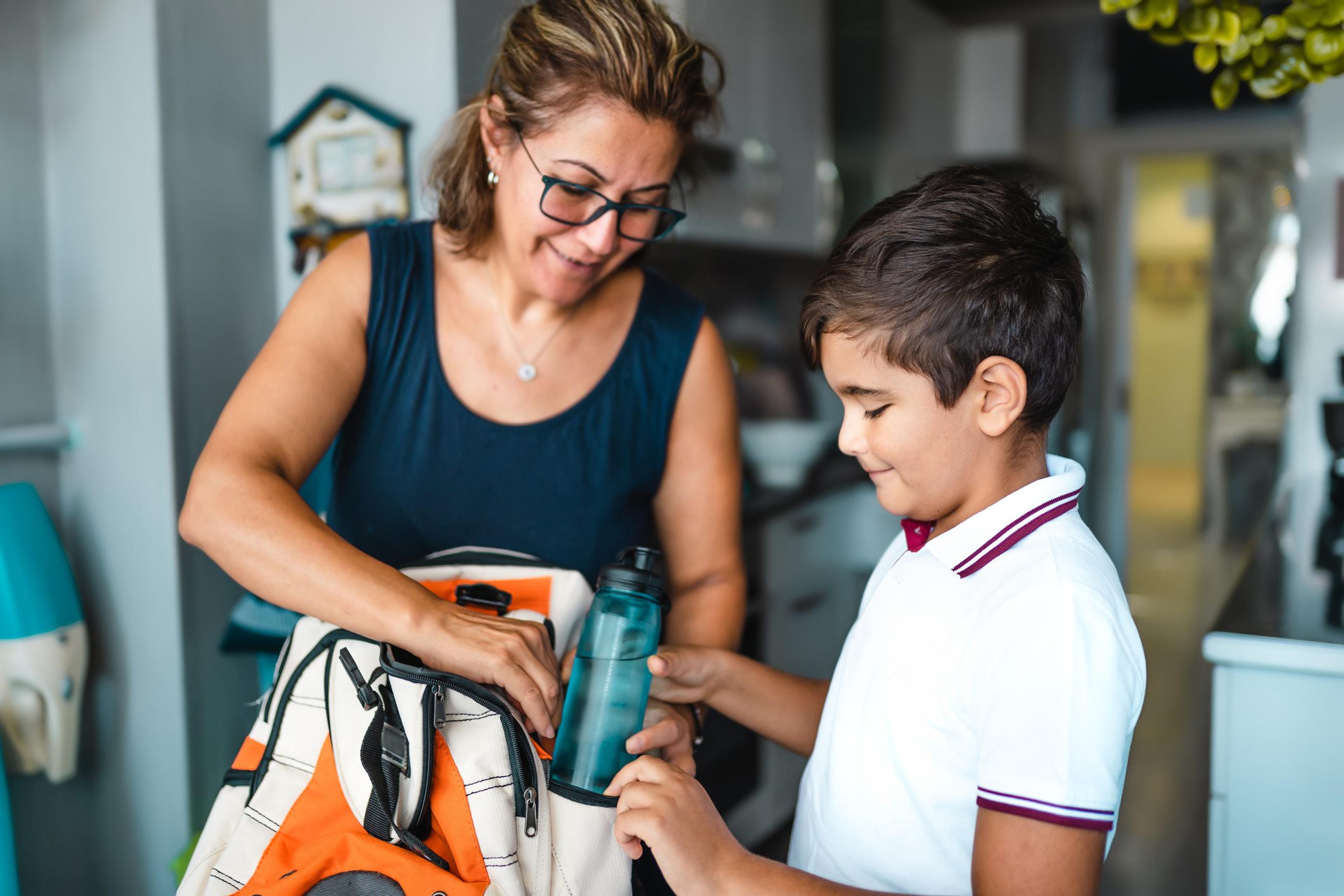 Mother helping her son get ready for school