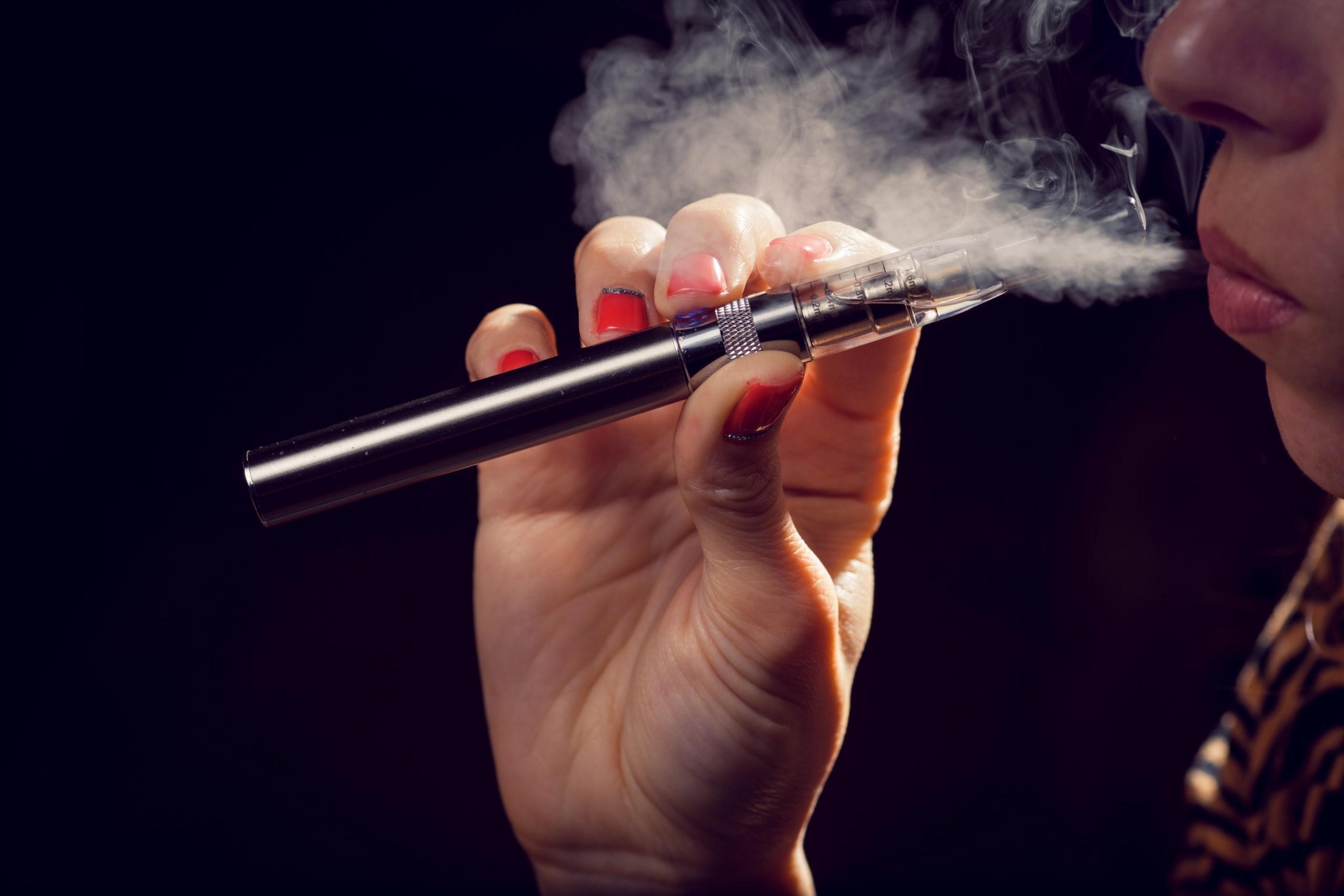 Teen exhaling from an e-cigarette