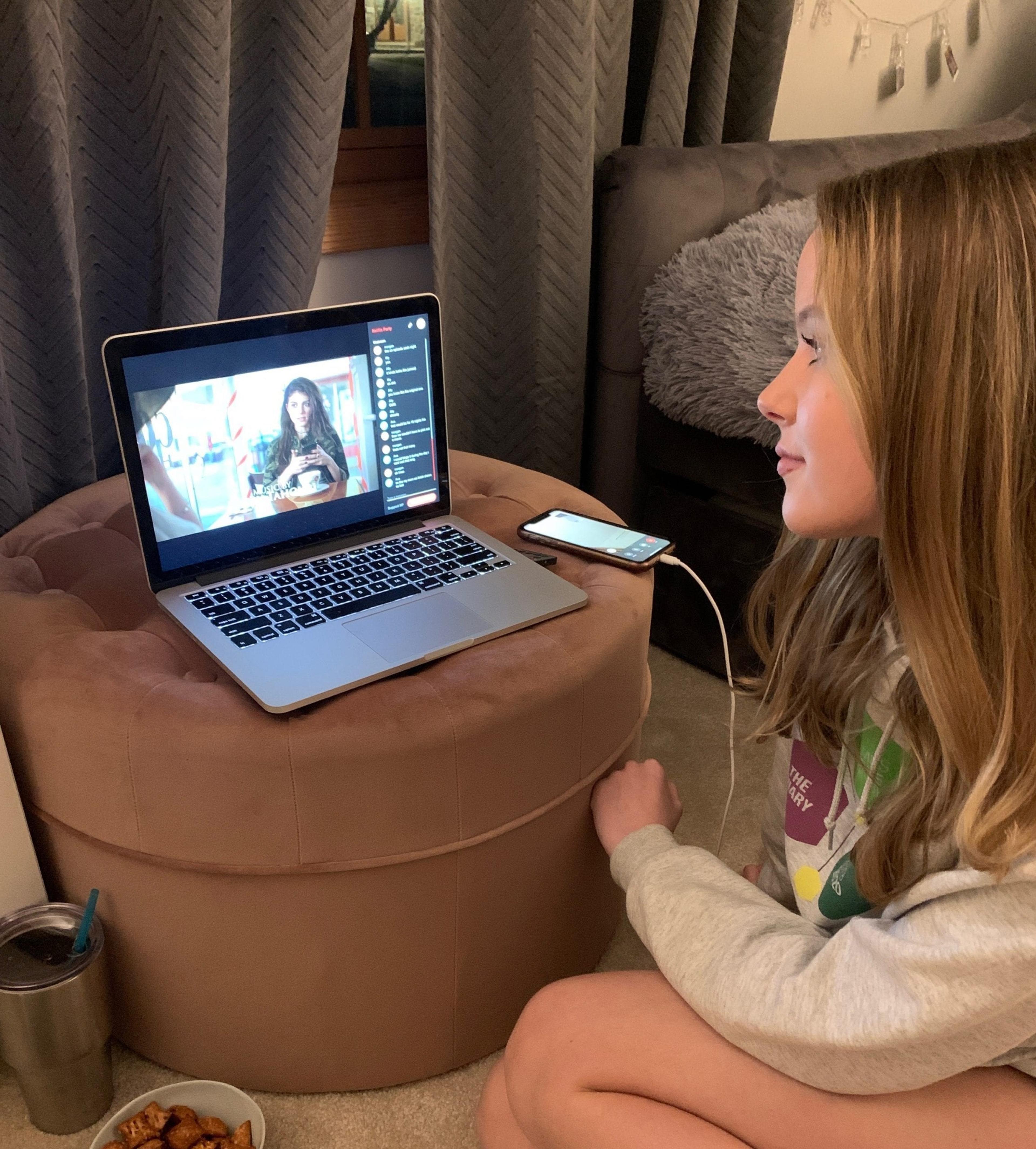 Lilly watching a movie "with" her friends.