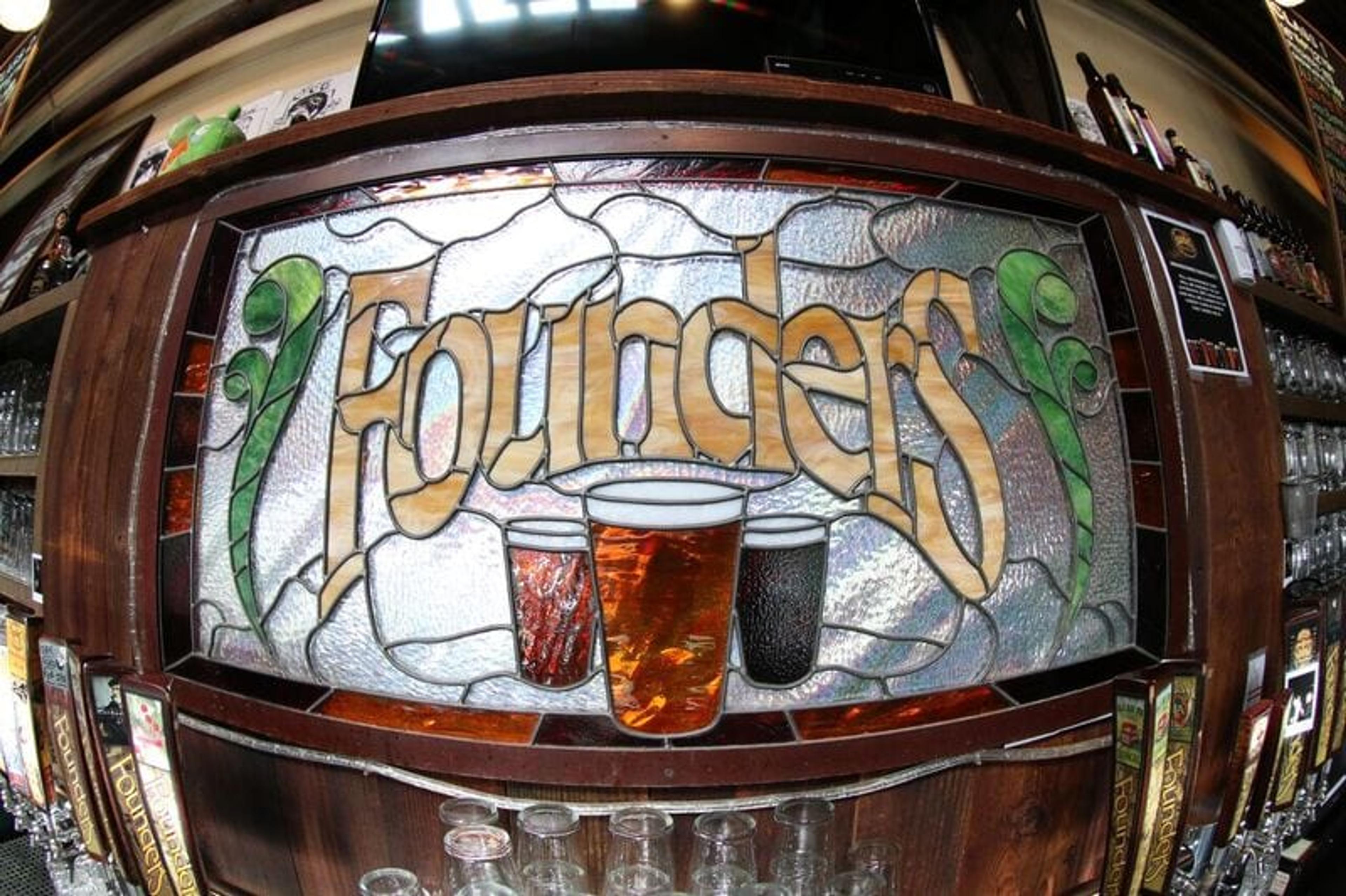 Stained glass sign that says Founders with beer glasses