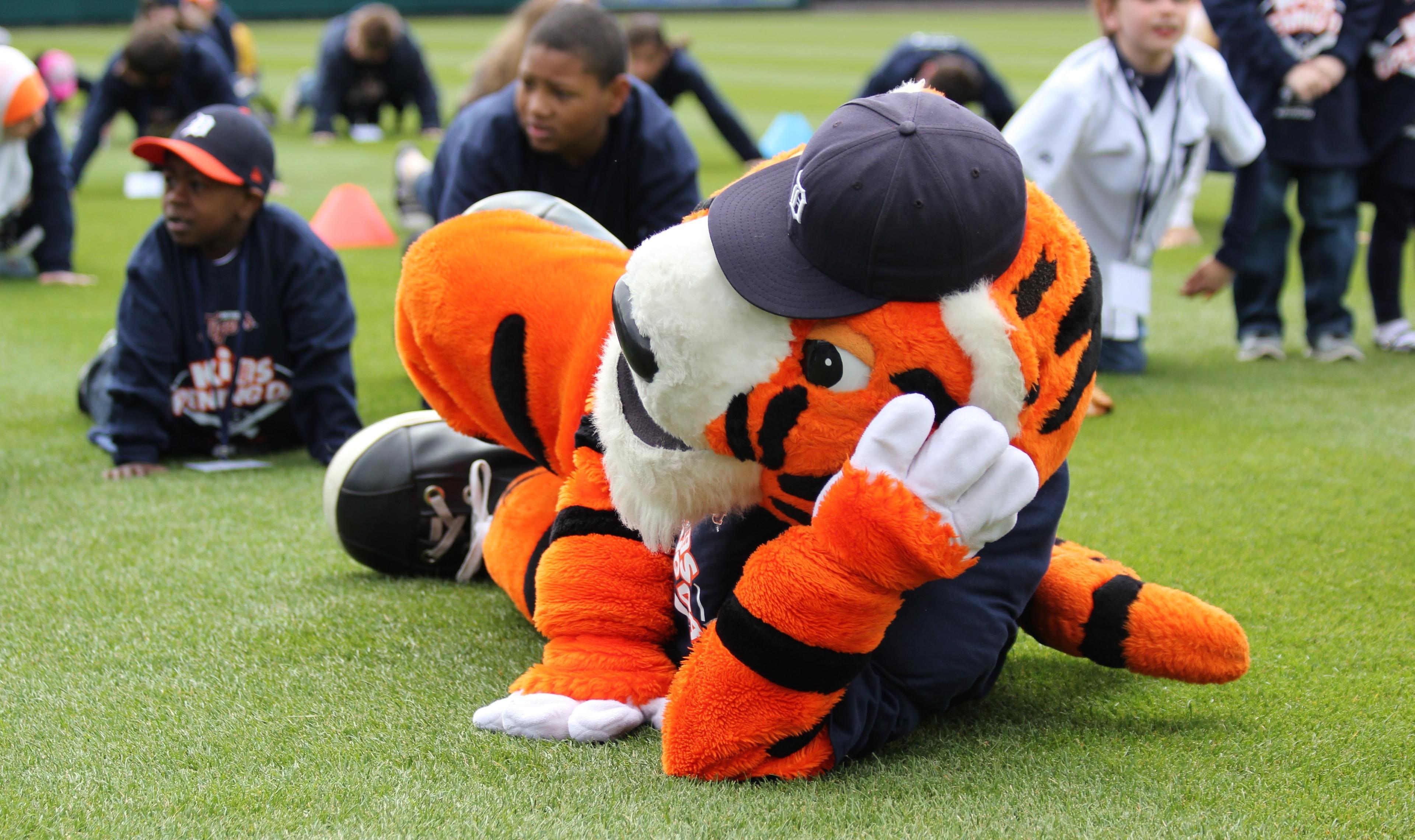 Tiger mascot laying down on the field