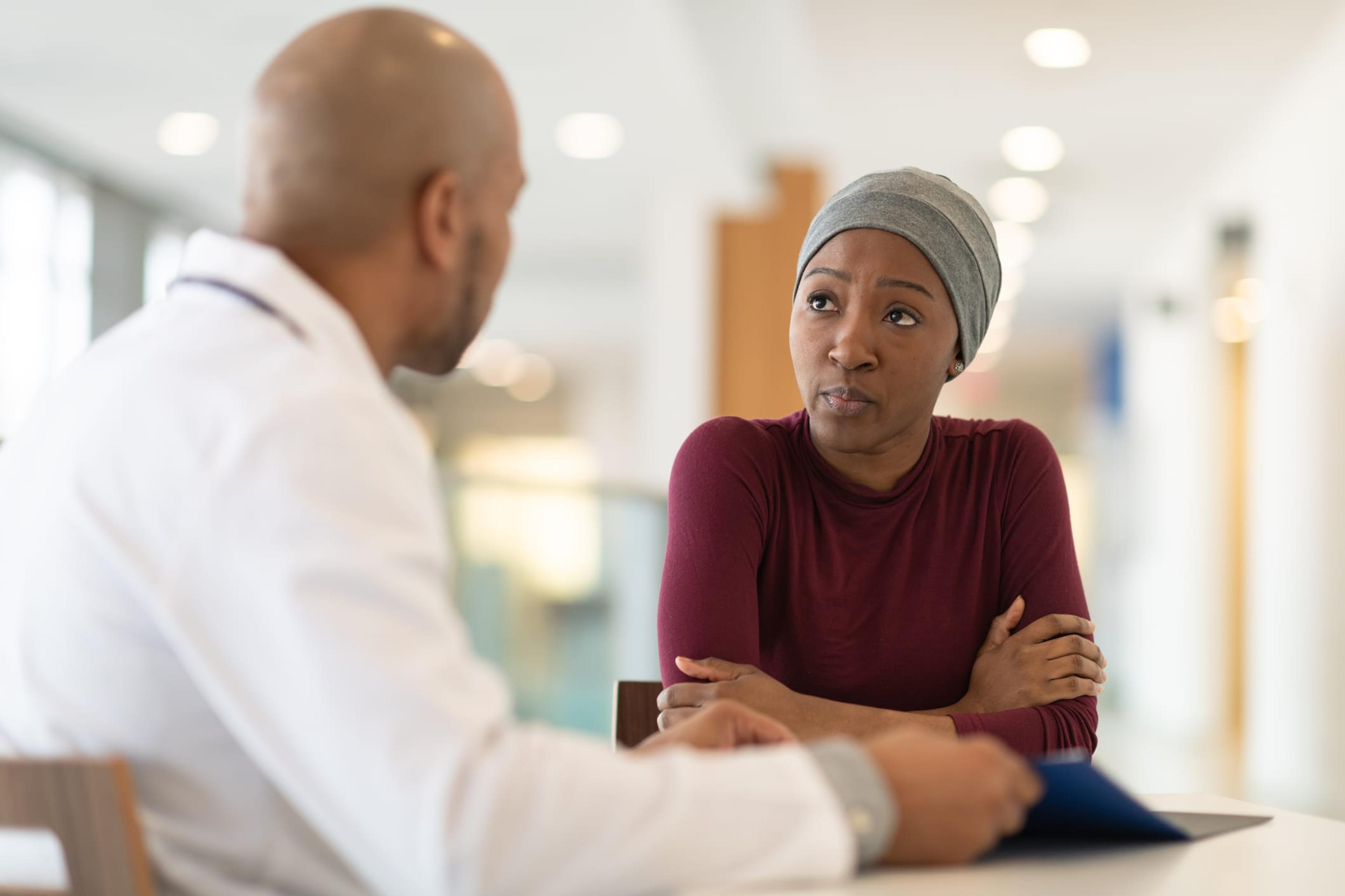 Young female cancer patient meets with doctor