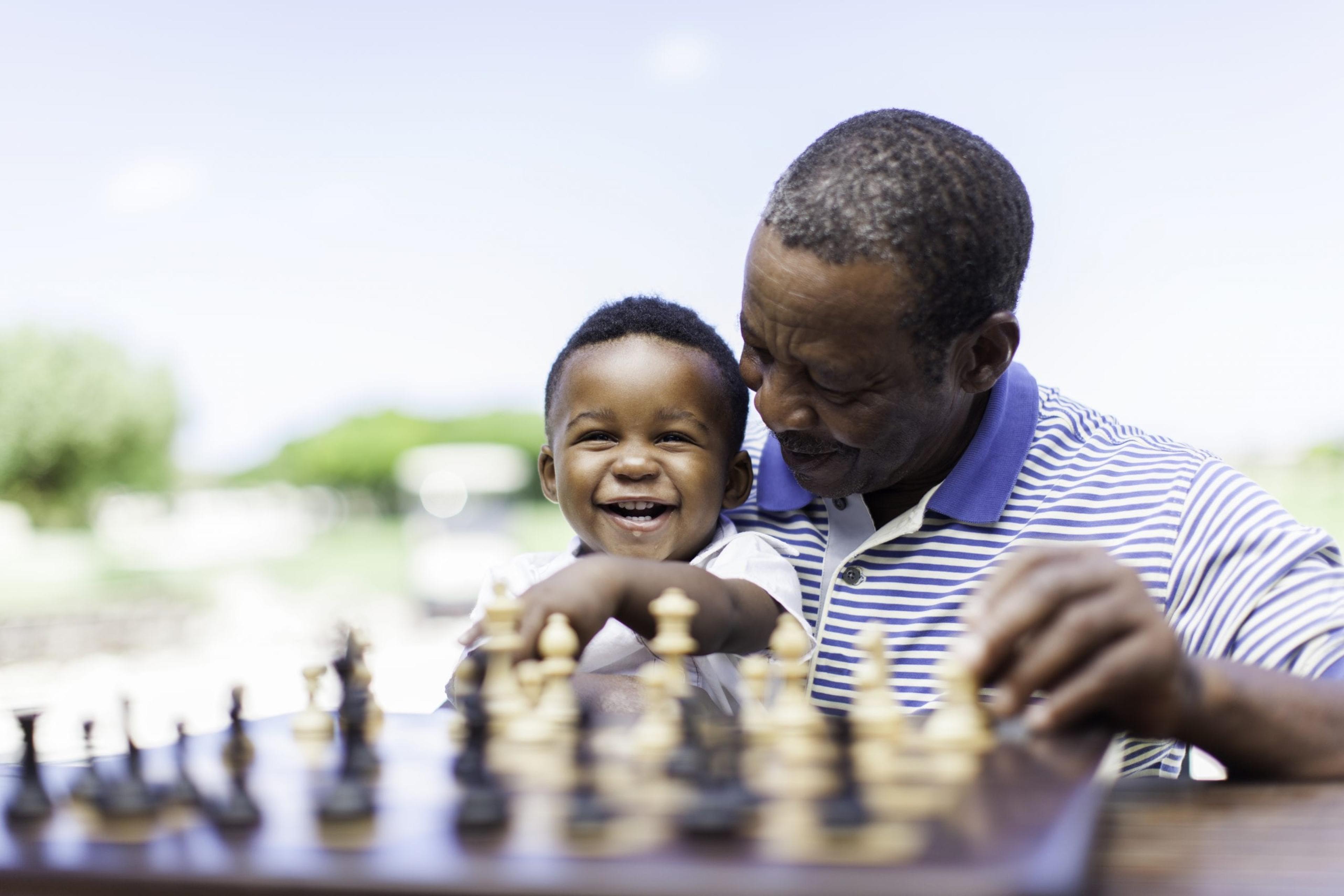 Grandfather playing chess with his grandson