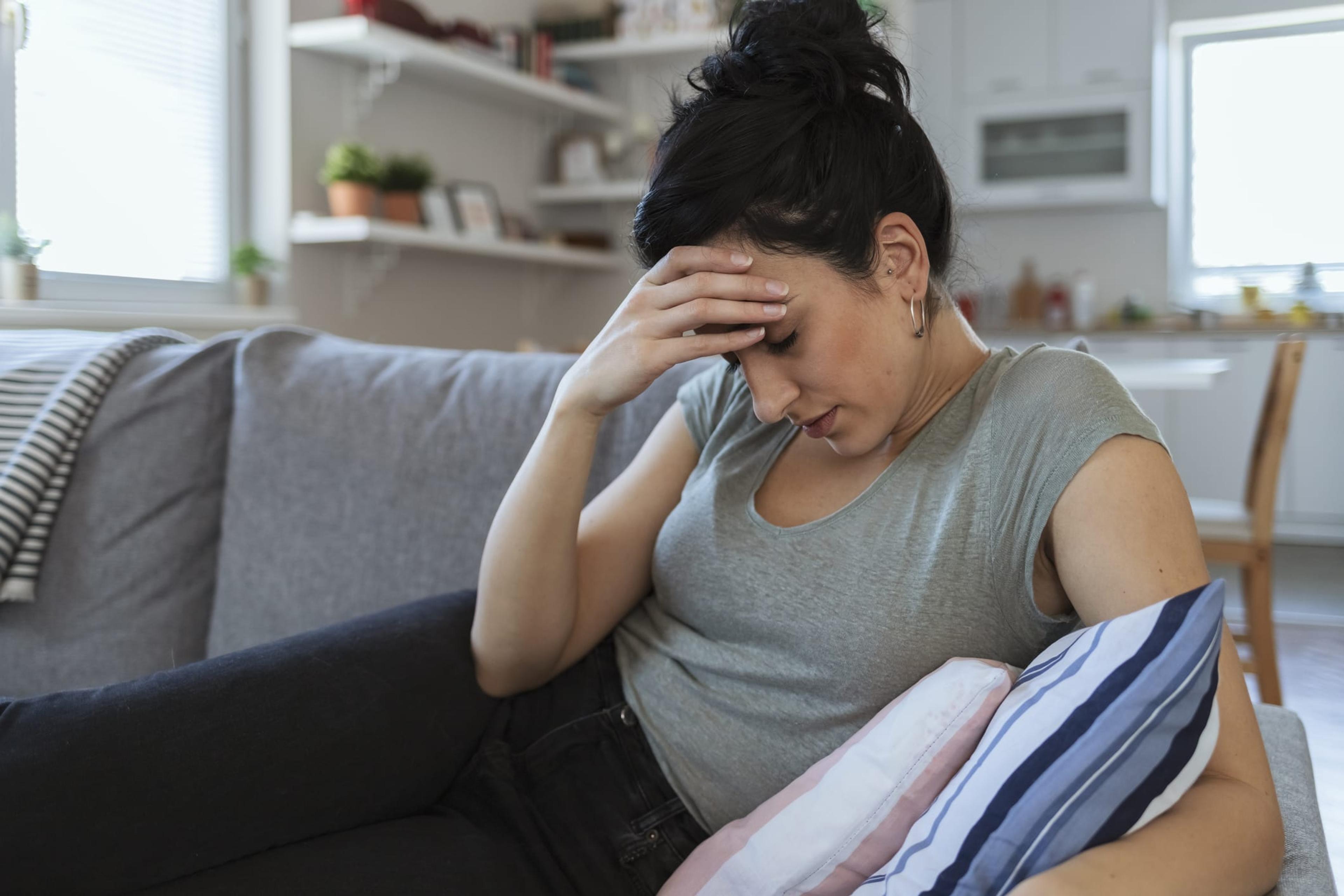 Stressed out woman sitting on the couch