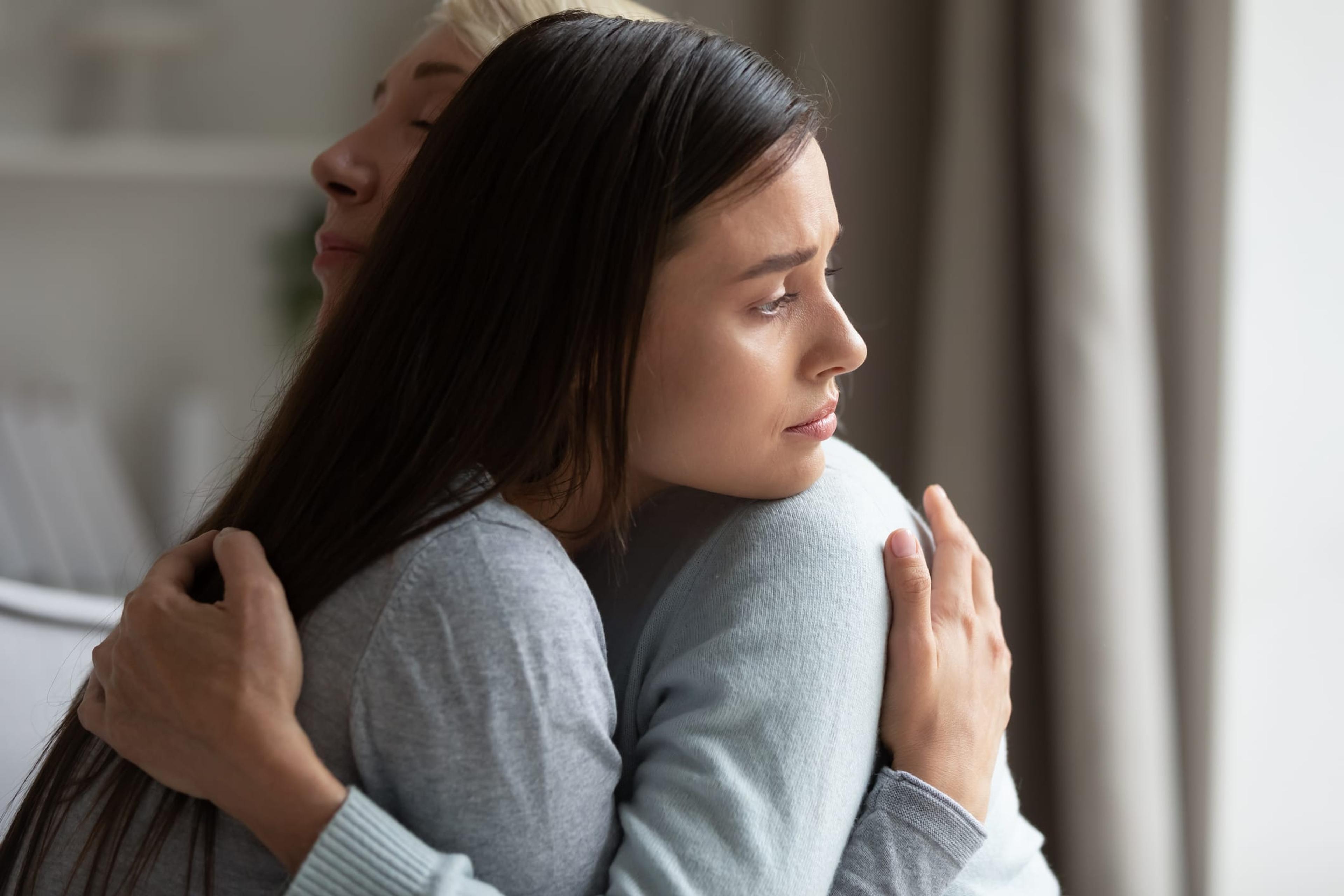 Woman hugging her adult daughter