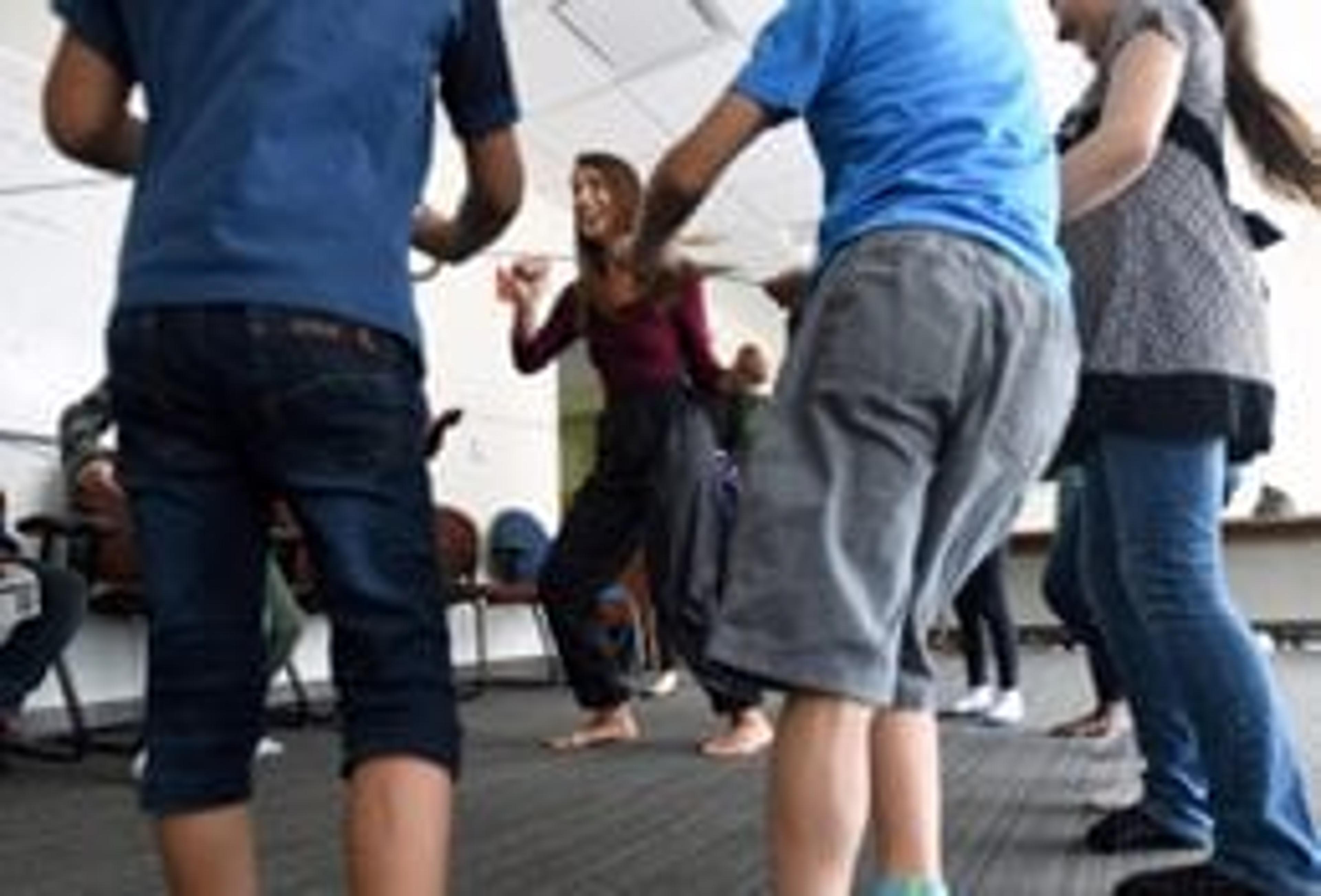 Lana Grasser teaching children a dance technique.