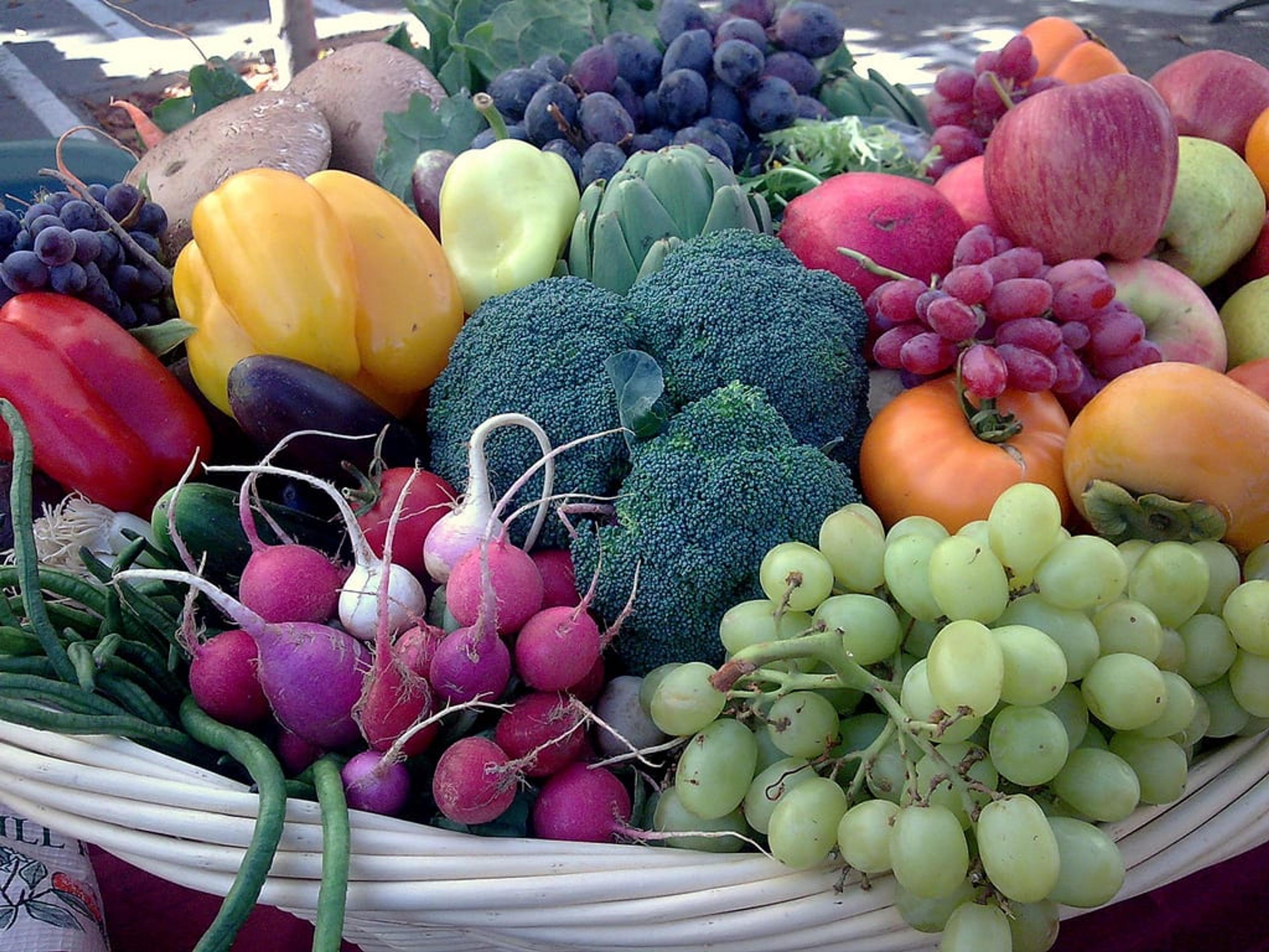 An overflowing basket of fruits and vegetables.