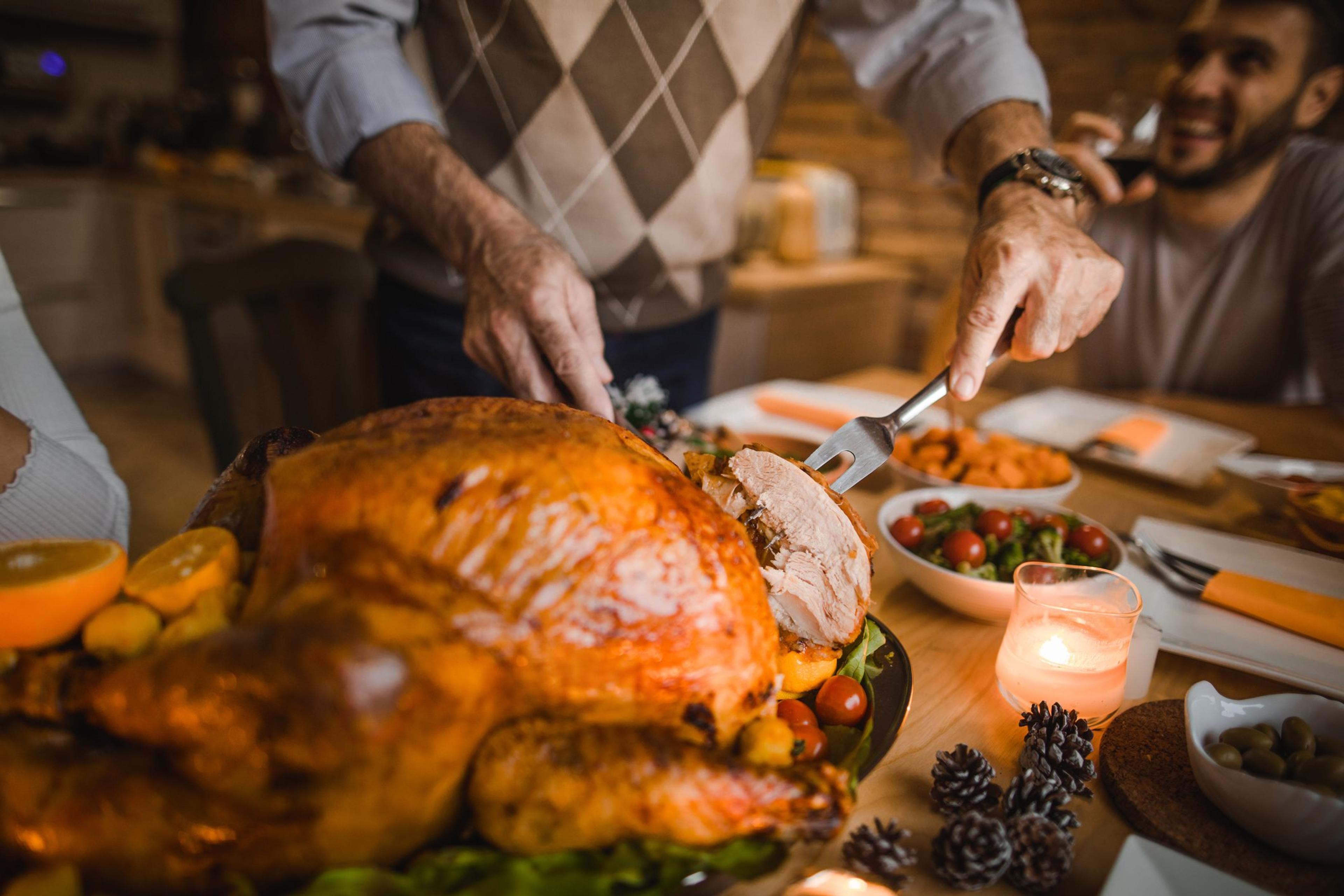 Close up of person carving a Thanksgiving turkey