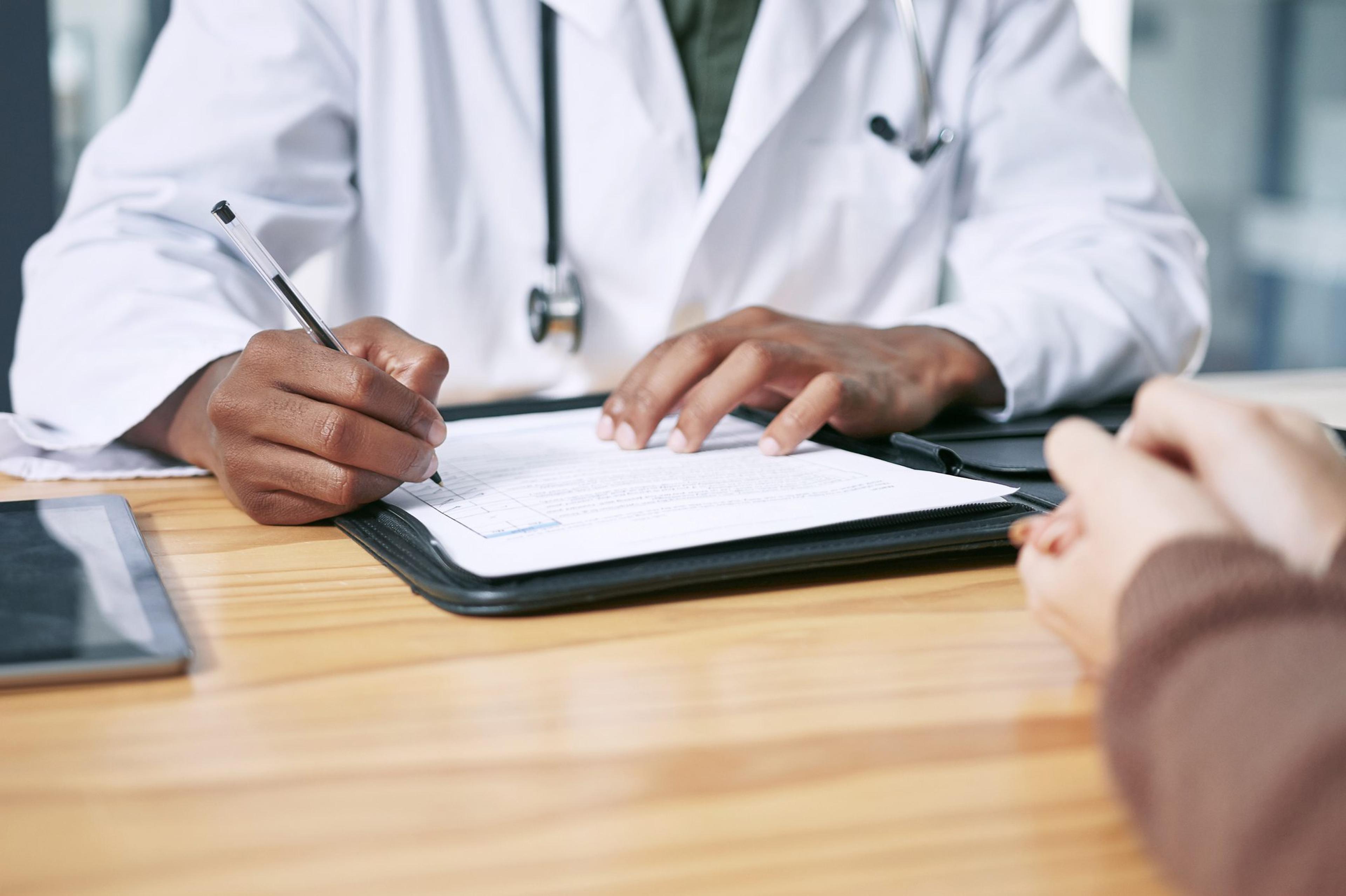 Doctor makes notes on a patient file