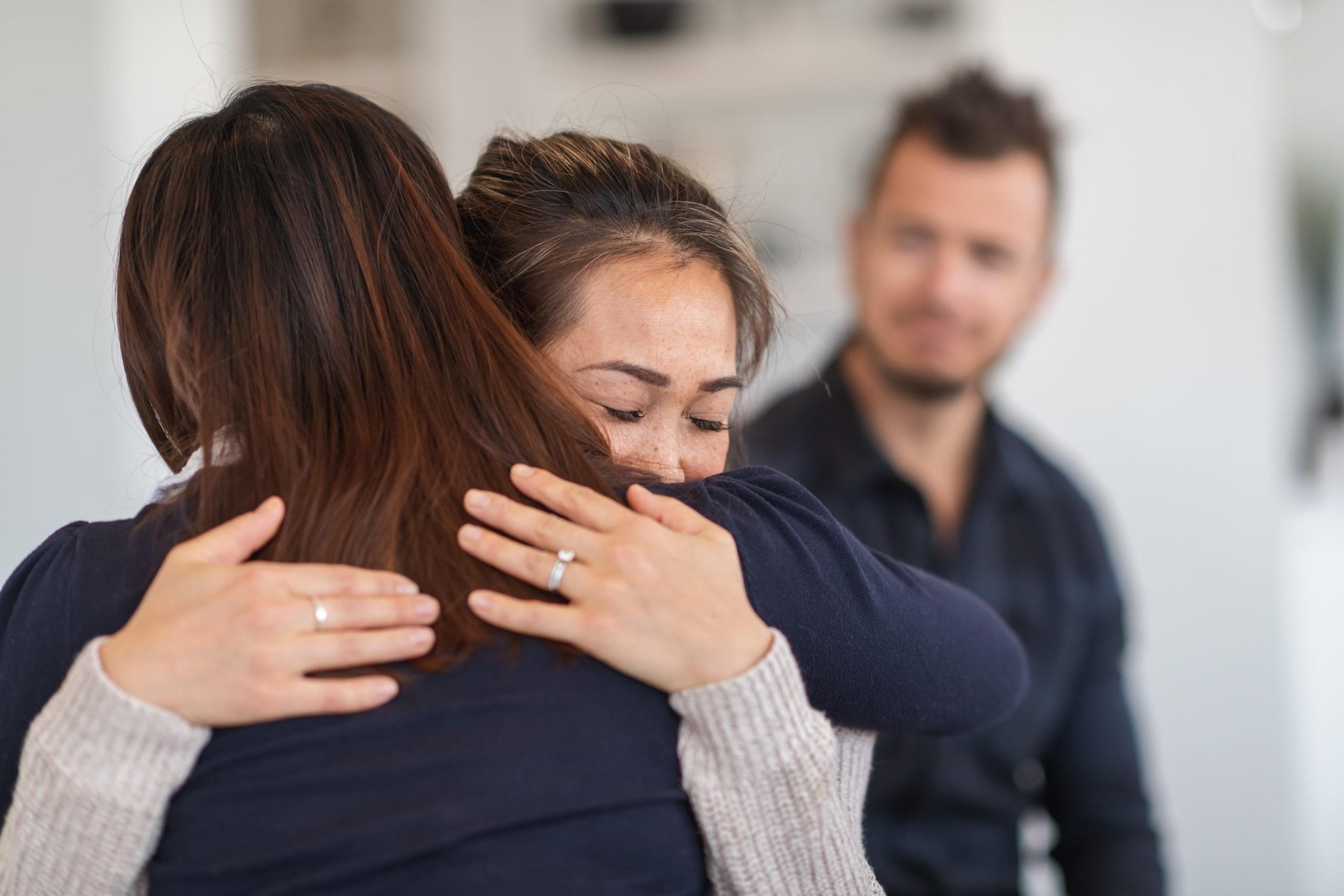 Women hugging during a support group.