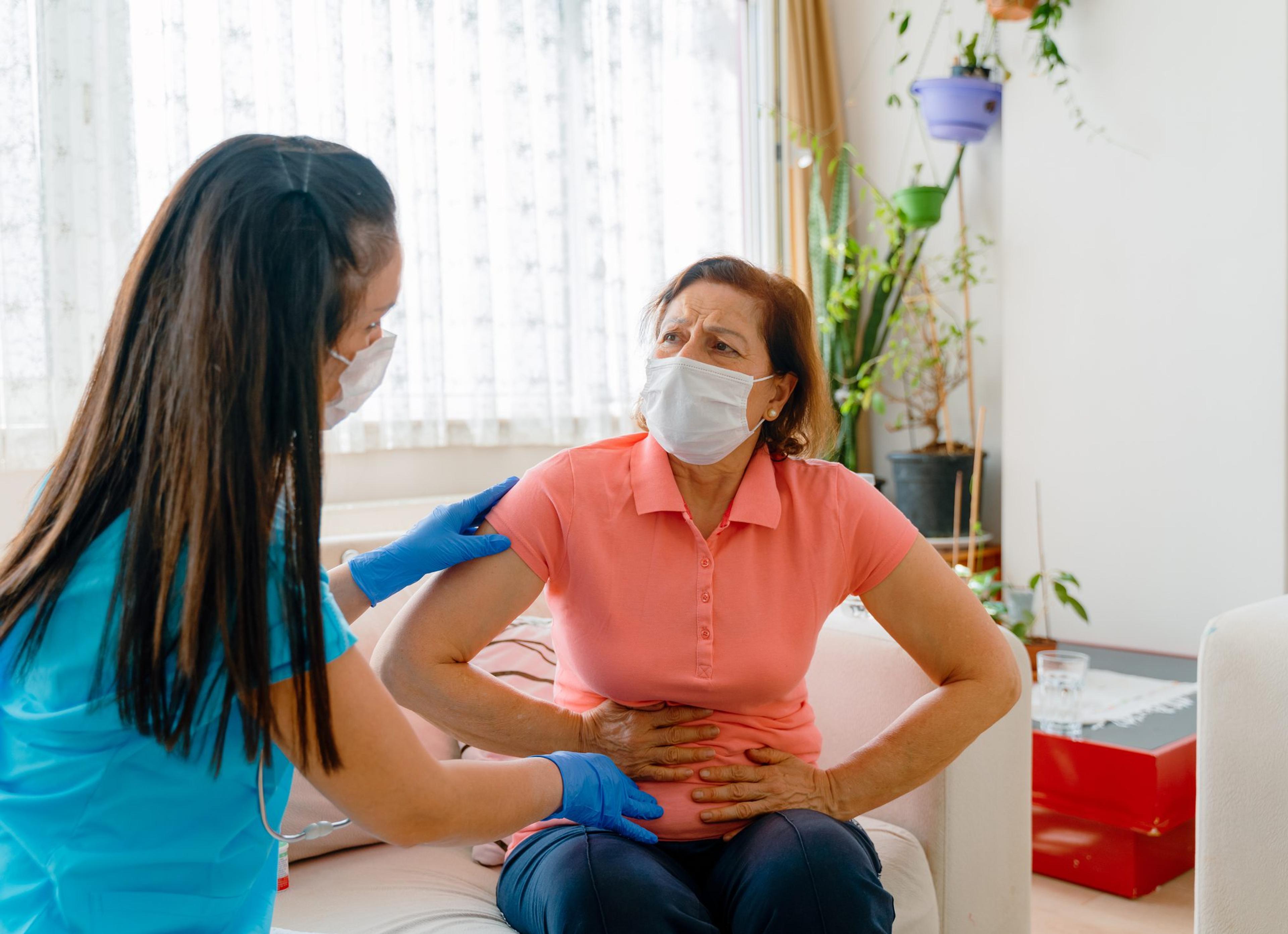 Abdominal pain patient woman having medical exam with doctor on illness from stomach cancer, irritable bowel syndrome, pelvic discomfort, Indigestion, Diarrhea, GERD (gastro-esophageal reflux disease)