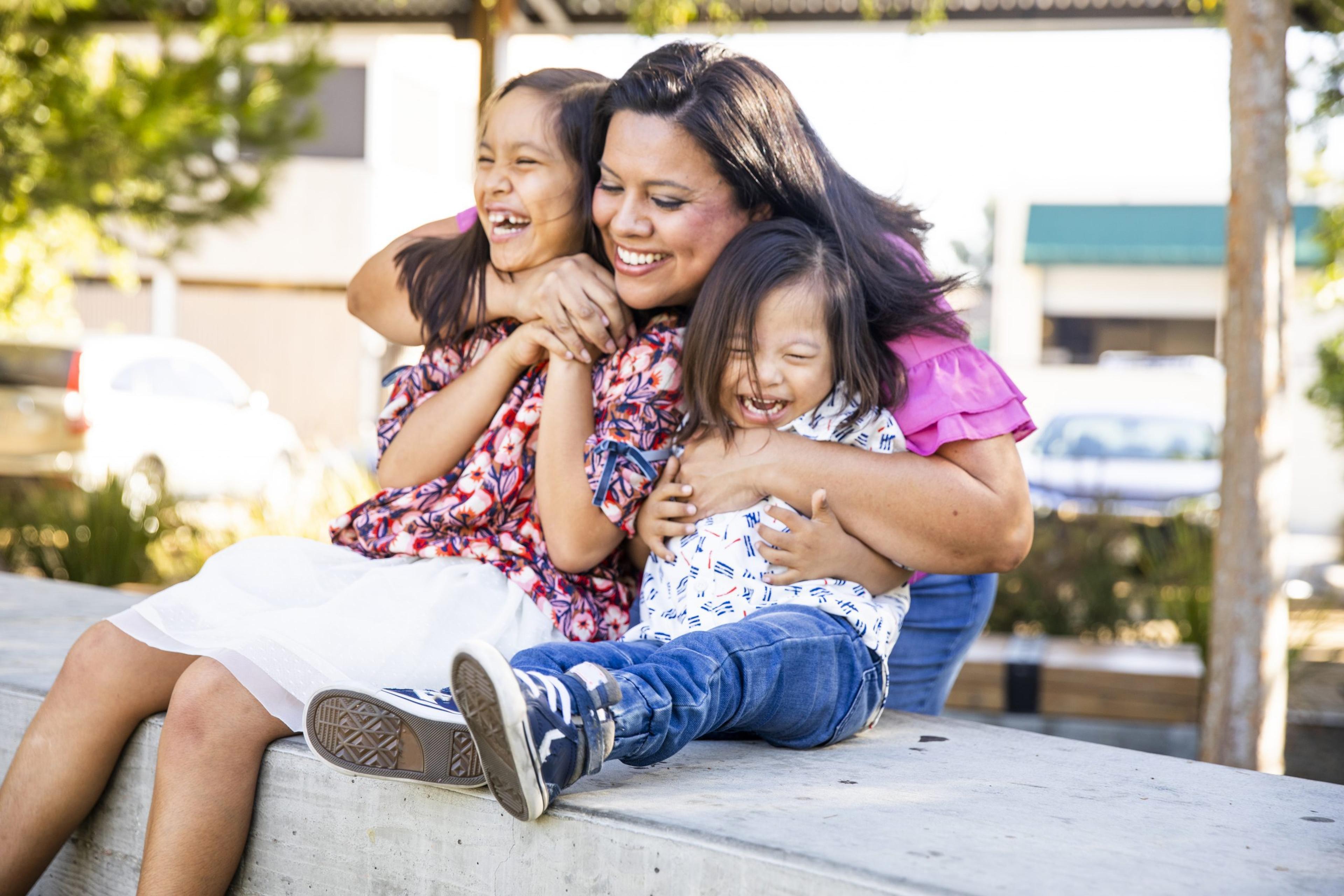 Hispanic Siblings Laughing in the Park