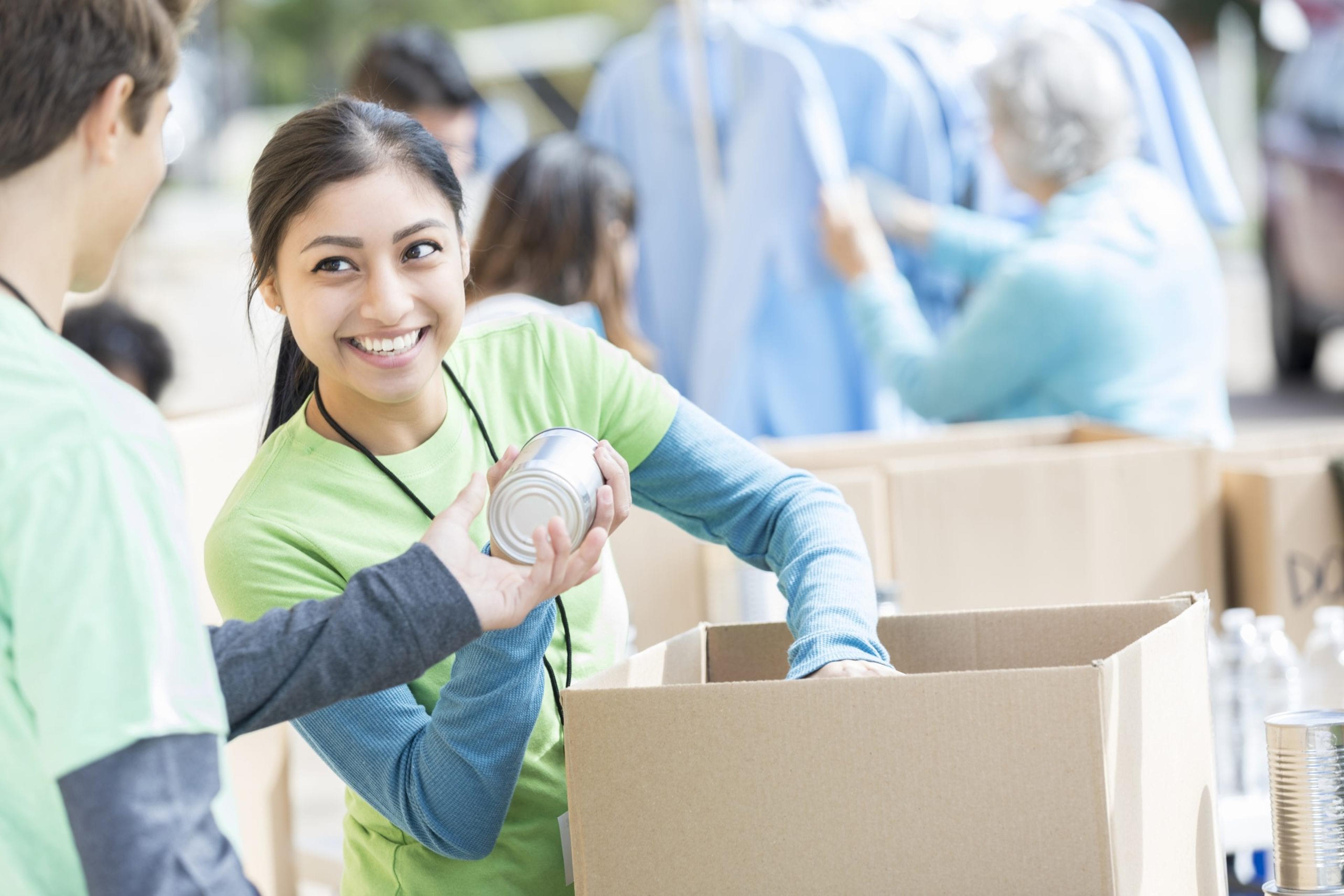 Volunteer sorting canned food.